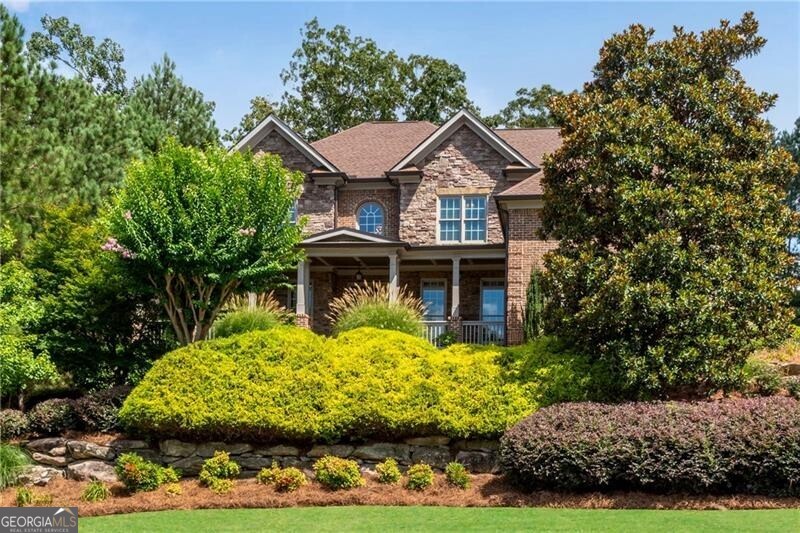 3-Sided Brick & Stone Executive home w/HUGE level fenced backyard! Built by one of the original Riversprings CUSTOM home builders from Vintage Communities Builder Group. True wrap around rocking chair front porch w/double doors to the dramatic two-story foyer featuring inlay design site-finished hardwood floors extending to the formal dining, kitchen and main level hallways. French doors to the main level study with intricate beadboard coffered ceiling. Formal dining w/extensive trim package and bump out for buffet or China cabinet. The soaring two-story great room features a stacked stone fireplace and built-in bookcases. Spacious island w/quality cabinets featuring a cabinet vent hood, walk-in pantry, gas cooking, below counter microwave and double ovens. Brick herringbone tile laundry/mud room w/cabinets, laundry sink and door to driveway. Hard to find main level guest bedroom plan that features a private full bath for bedroom + separate half bath for main living areas. You will feel like you are at the Four Seasons in this premium oversized primary suite featuring a tray ceiling, sitting room w/gas fireplace, spa bath w/jetted tub and separate double tile shower plus a massive custome closet! One upstairs bedroom w/private bath and other two share a jack & jill bath. Finished terrace level features a rec room, additional exercise room or office and a full tile bath. Several additional unfinished rooms for additional expansion. Relax outside on the covered porch w/stacked stone gas fireplace stepping down to the additional deck with plenty of room for dining area and grilling. Walk to the impressive amenity package including clubhouse, 4 tennis courts, soccer field, basketball, pool w/slide and playground! Great location w/easy access to HWY 316 and shopping at corner of 316 and HWY 316 featuring Target, Publix, HomeGoods, Belk, Michaels, Chick-Fil-A, Starbucks, LongHorn Steakhouse, AMC Theater and more!