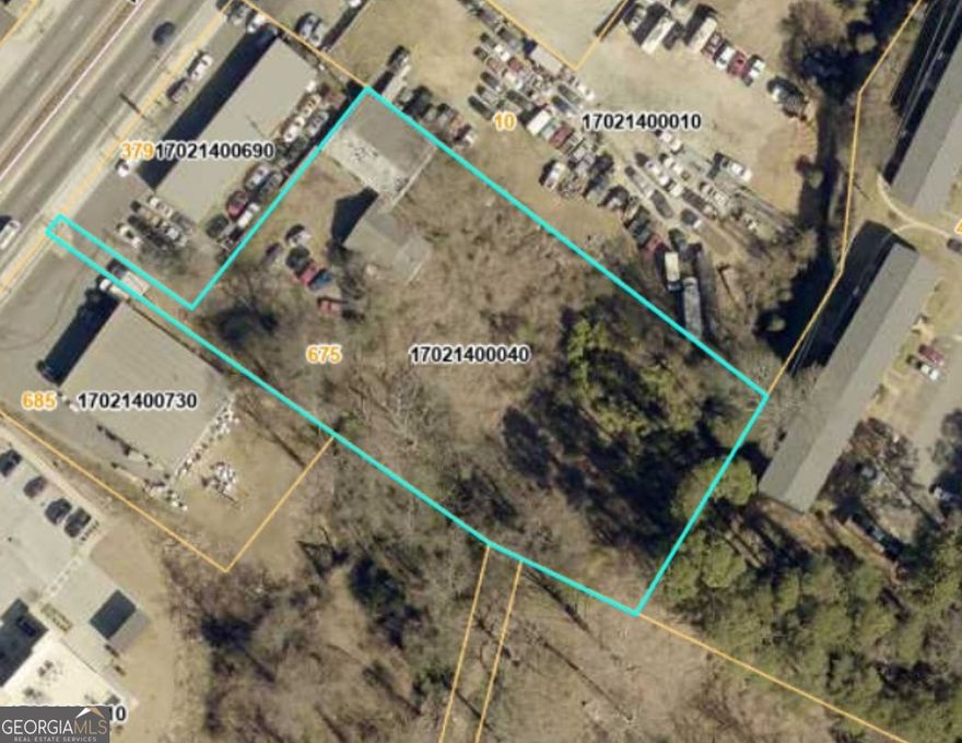 1.1 Acres Just 2 Miles from Marietta Square!  675 Powder Springs Street offers a rare redevelopment opportunity in the heart of Historic Marietta. Just two miles from the Marietta Square and positioned along a high-visibility corridor, this 1.1-acre site is perfectly suited for investors and developers seeking a prime location.  The property currently features a 40' x 50' three-bay garage and a separate office building with reception, three offices, a large workroom, kitchen, one full bath, and one half bath. Both the Garage and office are in need of rehab. The rear portion of the property remains undeveloped, providing flexibility for expansion, new construction, or a complete reimagining of the site.  Large parcels this close to Marietta Square are increasingly rare-don't miss your chance to secure a property with exceptional visibility and future potential. Sold as-is with no disclosures. Please contact the listing agent before visiting.