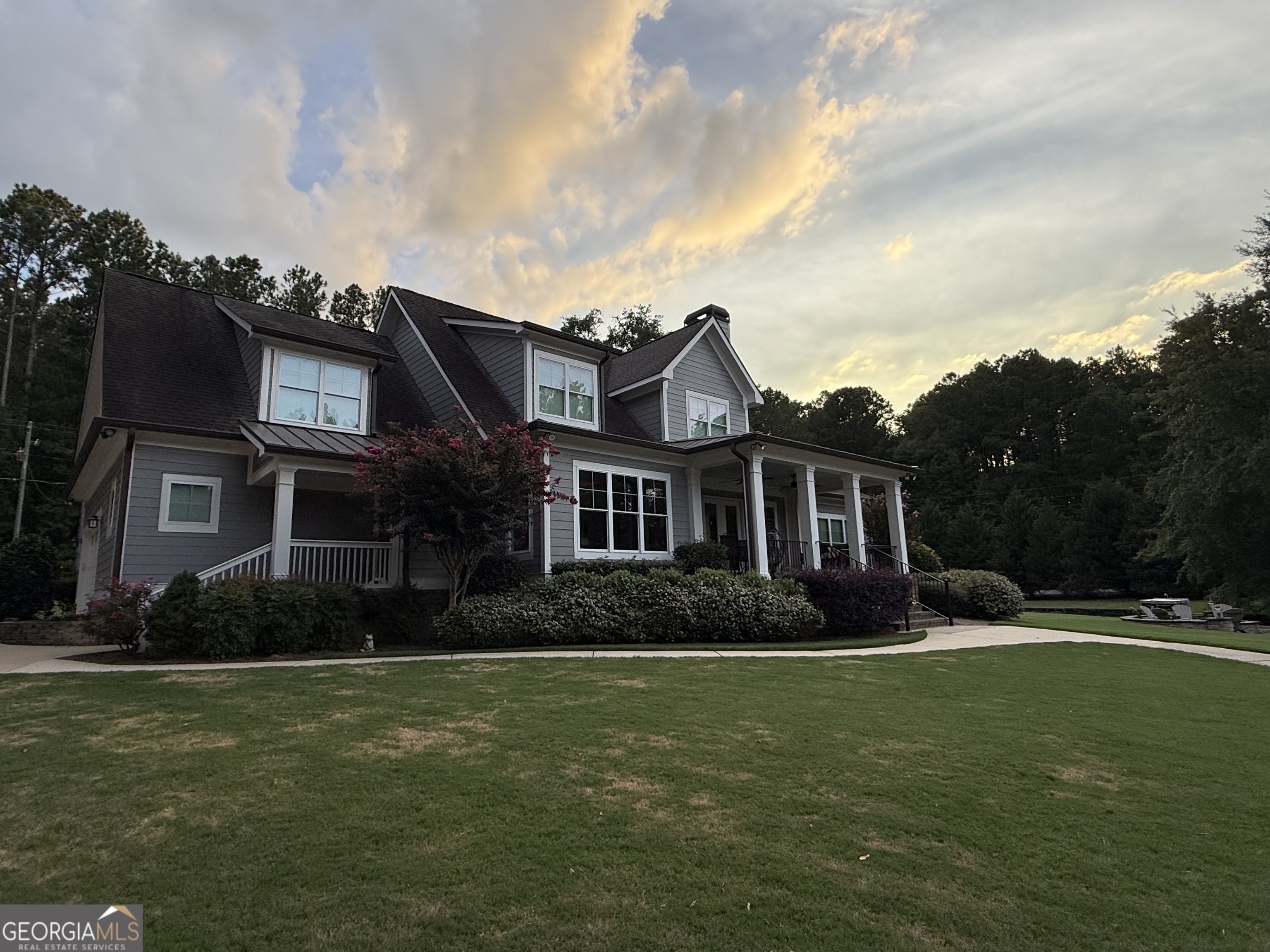 Welcome to 338 Sinclair Rd SE, Eatonton GA! This stunning property offers a rare opportunity to own a beautiful waterfront home on Lake Sinclair. Situated on a spacious lot with over 200 feet of water frontage, this charming home boasts panoramic views of the lake and a serene, private setting. As you approach the property, you'll be greeted by a well-maintained exterior featuring a lush lawn, mature trees, and a welcoming front porch. Step inside to discover a bright and airy open-concept living space with large windows that flood the home with natural light and offer breathtaking views of the water. The main level features a cozy living room with a fireplace, perfect for relaxing and unwinding after a long day on the lake. The open concept kitchen, dining and living room areas are ideal for hosting family meals or entertaining guests. The spacious kitchen is a chef's dream, complete with ample cabinet space, stainless steel appliances, and a center island for food prep. A large laundry room, mudroom and large pantry, office and guest room and full bath are additionally located on the main floor. The home offers four bedrooms, including a luxurious master overlooking the lake, a walk-in closet, and a spa-like ensuite bathroom with a soaking tub and separate shower. An additional guest room is available downstairs with an attached full bath, while upstairs two large bedrooms with walk-in closets and a beautiful lake view. Highlights of this property include architectural design specific for this lot to maximize view, full house generator, gas starter outside fire pit, two detached garages and workshops, parking in garages for 5 vehicles, PRIVATE boat ramp, large fenced in area for animals, seawall is set along entire fee simple lot and lease lot, and updated MAX boathouse with two boat lifts and sitting area. An adjacent lease lot to extend property is available.