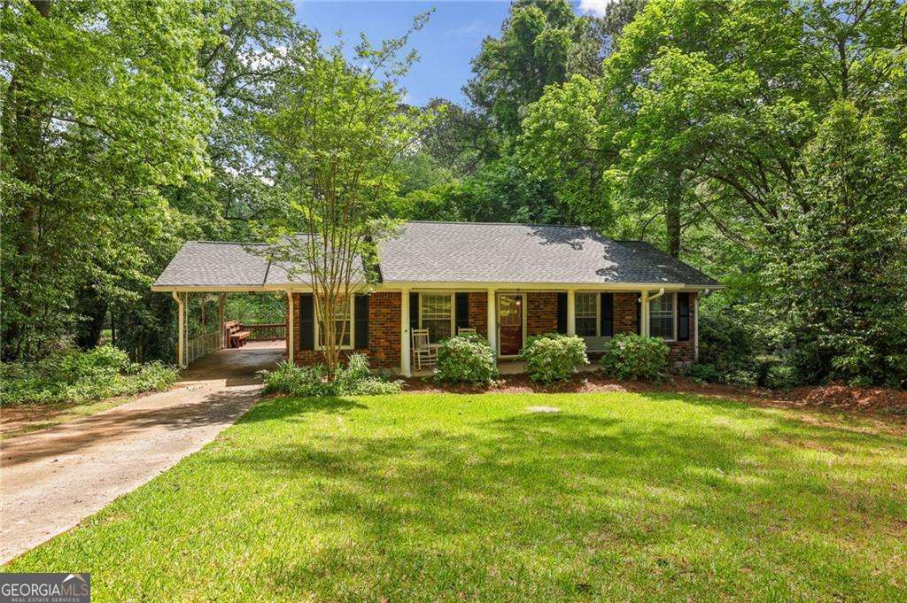 Welcome to this beautifully updated home nestled on an expansive 0.4-acre lot, offering privacy, charm, and convenience in one of Chamblee's most sought-after neighborhoods, Wakefield Forest. Surrounded by lush, landscaping, this move-in-ready property boasts freshly painted interiors and abundant natural light throughout. Inside, you'll find beautiful hardwood floors, a spacious family room perfect for relaxing or entertaining, and a separate dining room ideal for gatherings. The recently updated kitchen features stainless steel appliances, custom cabinetry, granite countertops, and plenty of sunlight. The updated bathrooms reflect modern taste and functionality, while the generous backyard deck offers a tranquil escape-perfect for entertaining guests or enjoying peaceful summer evenings overlooking your large, private and fenced-in yard. Located just minutes from Buckhead, Brookhaven, Emory, and MARTA, with quick access to I-85 and I-285, this home offers both serenity and city convenience. Don't miss this rare gem in the Brookhaven/Chamblee area! Buyers, this beautiful property qualifies for 100% financing (no downpayment required) through Truist's CHIP Program, subject to Borrowers qualifications. For more information contact Jeff Nicholson at Truist.