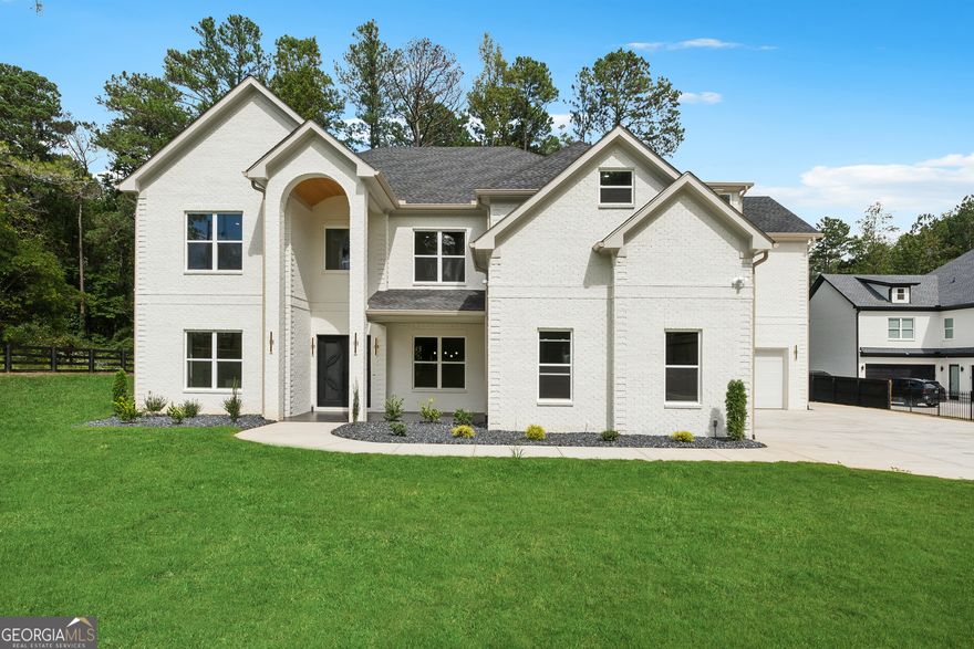 Ready to MOVE-IN, Custom built luxury home in Buford and Hamilton Mill. As you enter the home, you're greeted by a spacious open floor plan and strikingly beautiful hardwoods. Adjacent to the entryway find a lovely formal dining area large enough to sit 12 or more. The large space can also be fashioned into an office, cozy library or sitting room. Upon entering the living area, your swept away into a chic and modern atmosphere. High 2-story ceilings and large windows blend seamlessly into the modern decor and usher in warmth. A peek into the kitchen shows off a chef's dream! Elegant stone counters, custom cabinetry, and a gorgeous backsplash are just a few of the features that make cooking in your new kitchen a delight. The large island, Professional appliances, and bar seating make hosting a joy! Your owner's suite resides on the main level and boasts the same beautiful hardwoods as the rest of the main floor and tray ceilings. The bright ambience makes it the perfect space to unwind after a long day. Retreat into the en-suite bathroom and discover stunning tile work in an oversized shower with soaking tub! The secondary bedrooms upstairs are just as airy and bright as the rest of the home, with some boasting their own en-suite, and are perfect for a growing family. The oversized loft hold limitless potential and can be turned into the ultimate game room, cozy home theatre or dreamy playroom! Step outside into the backyard and take in the large, well-manicured lawn. Plenty of space for kids and pets to run and play or a prime opportunity to install your own pool! This home resides in a no HOA community and in a highly coveted location! Shopping, dining, parks, award-winning schools and all downtown Buford has to offer are just minutes away. Enjoy easy access to I-85 and 985, or take advantage of the close proximity and visit some of Georgia's most prestigious attractions like the Chateau Elan Winery and Resort! Book you're showing today and discover life in the culturally rich and exciting city of Buford! Estimated completion is September 2024.