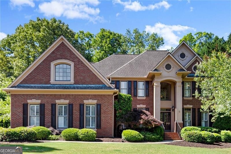 Welcome home to this beautifully maintained home located in the highly sought-after swim and tennis community of Hampton Hall in Alpharetta. Offering one of the largest floor plans in the neighborhood, this spacious four-bedroom, four full bathroom, and one half bathroom home sits on a generous 0.59-acre lot and is nestled within one of the area's top-ranked school districts. From the moment you walk through the front door, you'll be greeted by an abundance of natural light and a thoughtfully designed layout that effortlessly blends everyday comfort with spaces ideal for entertaining. The main level features a formal dining room and office. The two-story main living area includes built-ins, a fireplace, and expansive windows that allow sunlight to flow throughout the home. The white kitchen features stainless steel appliances and a breakfast nook. This open-concept design flows seamlessly into a screened-in porch, where you can unwind and take in the peaceful, private backyard. Whether gathered around the fire pit or enjoying the tranquil water feature, the outdoor space is truly an extension of the home. Upstairs, the oversized primary suite is a serene retreat with tray ceilings, rich hardwood floors, and large windows that fill the room with natural light. Three additional bedrooms and a spacious bonus room offer flexibility for growing families, guests, or a home office setup. The fully finished terrace level is a standout, complete with a custom bar, a dedicated workout room, and a large playroom with a stage-perfect for everything from game nights to creative performances. Hampton Hall is renowned as the premier swim/tennis community in the top-rated Johns Creek school district. It offers a variety of social activities, including a swim team, family events, four tennis courts, tennis teams, and a soccer field. The location is unbeatable! You can bike or walk to the Big Creek Greenway and Waters Road Park, and you're just minutes away from shopping, restaurants, recreation and nightlife in downtown Alpharetta, Avalon, Newtown Park, Ocee Park, and more! Don't miss your chance to experience the perfect blend of modern luxury and classic comfort in one of Alpharetta's most sought-after communities!