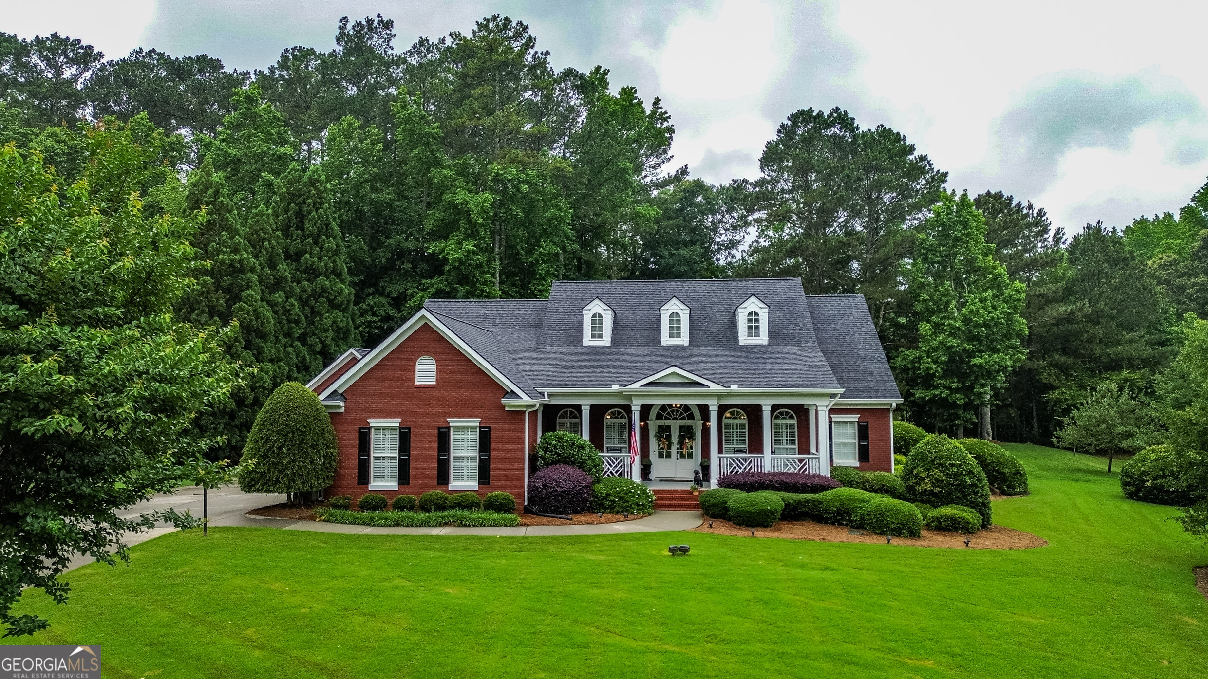 Welcome to this stunning all-brick ranch nestled in a desirable neighborhood on a sprawling 1-acre lot. This exquisite home boasts 5 spacious bedrooms and 4.5 baths, perfectly designed for both comfort and entertaining. Step inside to an open-concept living area that seamlessly blends the living room, dining space, and updated kitchen, all illuminated by soaring ceilings and an abundance of natural light from large windows. The oversized master suite is a true retreat, featuring a lavish master bathroom with a double vanity, a soaking tub, and a beautifully tiled shower, complemented by a generous walk-in closet. Two additional bedrooms on the main floor provide ample space for family or guests. Venture upstairs to discover a large bedroom with an en-suite full bath, ideal for privacy. The outdoor oasis features a spacious back deck overlooking a stunning in-ground pool complete with a tanning ledge, all enclosed within a secure fenced backyard-perfect for summer gatherings and relaxation. Additional highlights include a detached garage that offers a cozy living room downstairs, along with a bedroom and full bath upstairs, providing endless possibilities for in-law or teen suite, guests or a home office. This home has been meticulously maintained, featuring a new roof, recently updated kitchen, fresh paint, beautiful hardwood floors throughout, a central vacuum system, and a brand-new pool cleaner. Conventiently located and just a golf cart ride to Downtown shopping and dinning, just minutes from GWA, Monroe Golf & County Club and located in the Youth/ Walnut Grove school district. Don't miss the opportunity to make this remarkable property your own! Light fixture above the breakfast area does NOT remain with the home. A new one will be installed.
