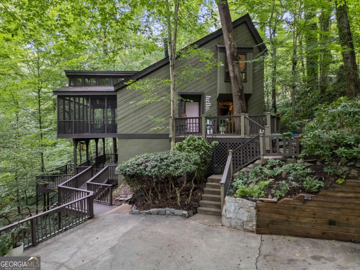 Wake up every day to the sights and sounds of nature-trees, birdsong, and a running creek-without sacrificing the conveniences of city living. This rare gem, tucked away in Sandy Springs and just moments from Buckhead, offers the perfect balance of tranquility and accessibility. This mid-century tri-level home welcomes you with timeless construction, character, and modern updates. The primary suite is conveniently located on the main level and opens to an enormous screened porch, creating the ultimate indoor/outdoor retreat. Inside, you'll find: Vaulted ceilings, open staircases, and walls of sliding glass doors Tongue-and-groove ceilings and real wood beams An open floor plan with generously sized bedrooms Recent updates include: Freshly painted interior and exterior New light fixtures on the main level Updated primary bath with new shower, tile flooring, vanity light. New stone kitchen countertops and electric range with Wi-Fi features New carpet throughout Decorative fencing added in several areas of the property New front door and decorative mailbox base All of this just minutes from Chastain Park, Trader Joe's, top restaurants, shopping, and easy highway access. Why buy a second home hours away when your private natural retreat is right here at 510 Forest Valley Road?