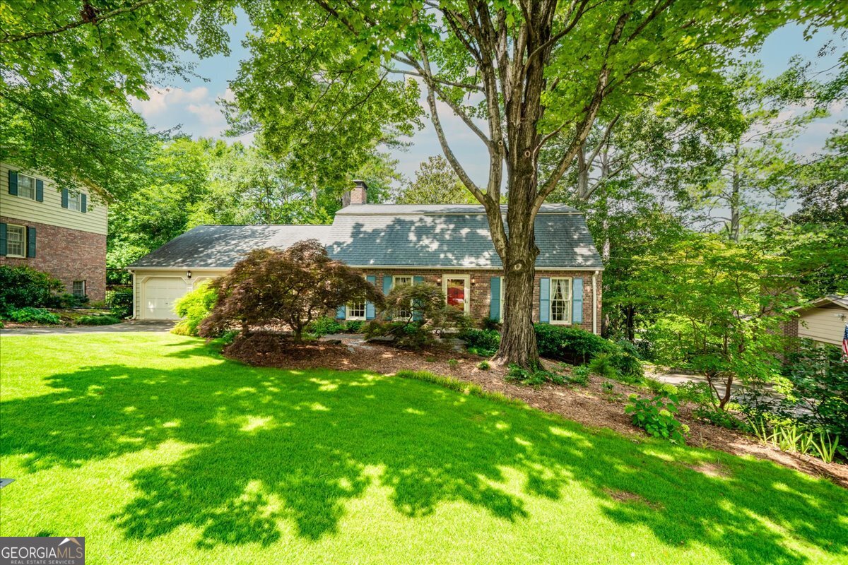 A 1969 Charmer in Country Squire Acres! Freshly painted and move-in ready, this original-owner home is located in the close-knit neighborhood of Country Squire Acres, where neighbors still stop to chat on their walks. Lovingly maintained, it boasts large rooms, a well-designed floor plan, and an incredible amount of storage. (Fun fact: An identical home was even featured in a Home and Garden sweepstakes ad in 1973!) The family room is the heart of the home with its own entrance and front porch. From there, you can access the kitchen and the screened porch, which overlooks a lovely shade garden. The kitchen, updated with Wolf cooktop, Insinkerator disposal, GE oven and Zephyr hood, Corian counters, tile back splash and under-cabinet lighting is large enough to add a center prep island. The double-door pantry includes laundry hookups, though there's also a dedicated laundry room on the lower level, complete with a laundry chute from the upper floors. A main-floor bedroom and bathroom are perfect for guests, an office, or crafts. Upstairs, the primary suite offers an ensuite bath, while two additional bedrooms share a hall bath. You'll also find access to an expansive attic over the garage. The lower level includes a rec room (finished), workshop, laundry and storage room with shelving, plus a separate storage area accessible from the yard for lawn and garden equipment. Enjoy unbeatable convenience: steps from the neighborhood pool and tennis courts, Druid Hills Middle School, Shamrock Forest (a favorite for dog walks) and the back entrance to Laurel Ridge Elementary. A mile of sidewalk takes you to Shamrock Plaza for shopping. Minutes away from Emory, CDC, Children's Healthcare and I-285. This home checks every box for space, convenience and community!