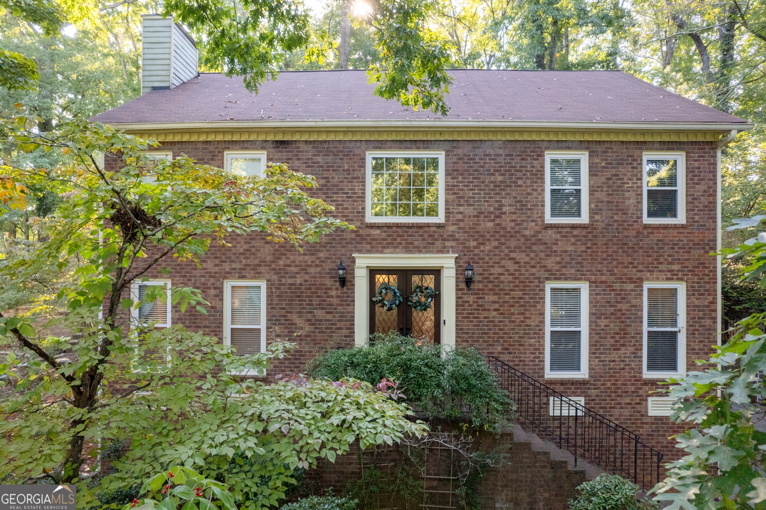 Welcome to this classic and beautifully updated brick home located in the highly sought-after swim and tennis community of Lansdowne. This beautiful property offers a perfect blend of modern updates and timeless charm, ideal for comfortable living and entertaining. Upon entering, you are greeted by a welcoming foyer that opens to a bright living room featuring double French doors and an elegant dining room. The spacious family room boasts a cozy fireplace, creating a warm and inviting atmosphere. The adjacent kitchen is a chef's delight, featuring white cabinetry, stone countertops with a stylish tile backsplash, and stainless steel appliances including a gas range. A convenient computer nook/desk and a sunlit breakfast area complete this functional space. The kitchen opens to a charming sunroom, providing seamless access to the outdoors. Step outside to enjoy the expansive deck, complete with a covered hot tub and patio area, overlooking the private backyard perfect for outdoor gatherings and relaxation.The upper level features an oversized owner's suite with a tray ceiling and a luxurious updated bath. The ensuite includes a vaulted ceiling with a skylight, a double vanity, a separate shower, and a freestanding soaking tub. A large custom walk-in closet provides ample storage. Three additional secondary bedrooms share a well-appointed hall bath. The laundry room rounds out the upper level. The finished terrace level offers exceptional versatility, featuring a kitchen, bedroom, full bath, a second laundry area, and a separate entrance ideal for an in-law suite or guest accommodations. Located in a vibrant neighborhood with outstanding amenities including a clubhouse, pool, tennis courts, and a serene lake, this home is perfectly situated near shopping, dining, parks, and major highways (I-75 and I-575). It is also within the highly acclaimed East Cobb School District, offering top-rated educational opportunities. Don't miss the opportunity to make this exceptional home yours!