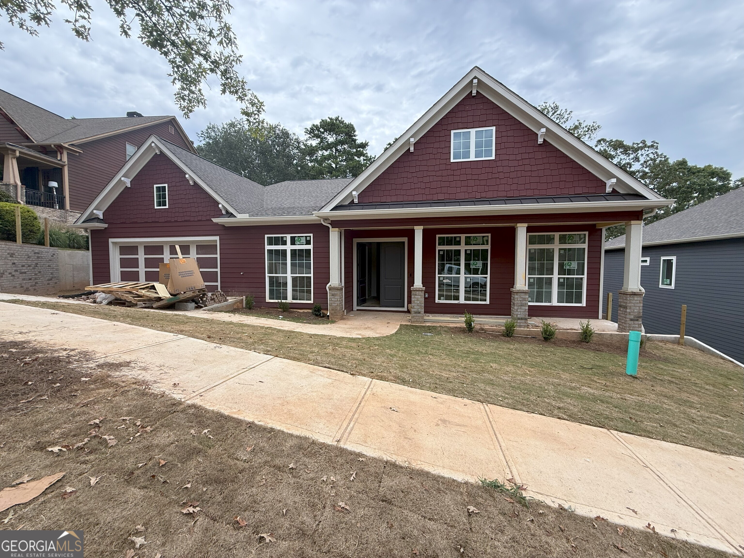 Professional photos coming next week. Showings will open up on 9/9/25 Seller and preferred lender are contributing to buy down your rate to 4.99% for qualified buyers! Plus, enjoy peace of mind with a 2-10 builders home warranty. Even better - homes of this quality are typically priced at least $20 more per square foot, giving you luxury at unmatched value. Seller also has 6 additional lots available in Tributary at New Manchester 4 of which have not started construction yet and 5 homes under construction in Tributary at The Villages. Flooded with natural light from expansive picture windows, this modern craftsman ranch combines timeless design with elevated upgrades. Step through the double wood doors into a tile foyer that opens to soaring 10-foot ceilings, 8-foot doors, and wide plank wood floors. At the heart of the home, the chef's kitchen features an oversized quartz island with sink, 8-foot tall cabinets, stainless vent hood, quartz counters, pendant lighting, and a walk in pantry. Flow easily into the dining room with wet bar and living areas or spend time relaxing on your private rear deck. Every oversized bedroom includes a spa-inspired ensuite with quartz countertops, frameless glass showers, anti-fog mirrors, marble tile, and thoughtful details. The owner's suite adds a freestanding soaking tub for the perfect retreat. A finished open stairwell leads to the basement, already stubbed for 2 more baths, offering endless possibilities for future expansion. Additional highlights include a tiled laundry with wash sink, LED lighting throughout, and carefully selected finishes that make this home shine above the rest. Set on .38 acres near Lions Gate in Douglasville, all homes in the Tributary subdivision have amenities such as sidewalks, Clubhouse, community swimming pool, tennis courts. Close by you have several golf courses, shopping, parks, hiking, biking, dining, shopping, Sweetwater Creek State Park. It's a short drive to Atlanta and much more. Light-filled luxury, thoughtful upgrades, and unbeatable value - this home was built to impress.