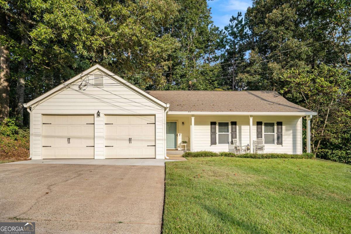 Charming One-Level Ranch in Prime Woodstock Location! Discover this adorable, cozy one-level ranch nestled on a spacious .38-acre lot, perfectly situated near Woodstock with easy access to shopping, dining, and entertainment. This move-in-ready home has been thoughtfully updated with modern touches and offers incredible flexibility for your lifestyle. Recent Upgrades (Last 2 Months): Durable Hardie Plank siding, energy-efficient vinyl windows, electric panel and fresh exterior paint. 2022 Updates: 7 new interior doors, restored kitchen cabinets with trendy subway tile backsplash, dishwasher and kitchen sink, 3 modern ceiling fans, updated main bath toilet, Luxury Vinyl Plank (LVP) flooring in 3 bedrooms. Outdoor & Additional Features: Expansive paver patio with a retaining wall, perfect for entertaining, approx. 10x12 storage building in the backyard for extra space. Versatile 2-car garage with a non-load-bearing wall creating two rooms-ideal for an office, storage, or hobby space (easily removable for full garage use). Additional Perks: Connected to public sewer, No HOA fees, No rental restrictions-perfect for homeowners or investors! Don't miss this opportunity to own a beautifully updated ranch in a fantastic location with plenty of charm. Schedule your showing today!