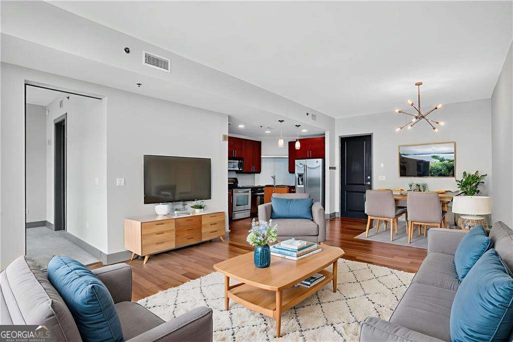 Live above it all in this 12th-floor condo at The Manhattan - a full-service building offering resort-style amenities and unbeatable convenience. This home features hardwood floors, a carpeted bedroom with generous walk-in closet, abundant natural light, and generous space for both living and dining areas. Enjoy a cup of coffee or evening cocktail on your private balcony with views overlooking the 8th-floor dog park, tennis/pickleball court, and outdoor garden with grilling stations. The kitchen features stainless steel appliances and an in-unit laundry adds everyday ease. One assigned garage parking space is included. Just outside your door, enjoy The Shops at Ashford Lane with its restaurants/shops and community events like farmer's and artisan markets, Politan Row Food Hall, and SuperTarget. Perimeter Mall and MARTA are right around the corner, and you're minutes from GA-400, I-285, St. Joseph's, Northside and Scottish Rite Hospitals. The Manhattan offers 24/7 concierge service and an incredible lineup of amenities: guest suite, pool, fitness center, club room, golf simulator, dog park, tennis/pickleball, and the stunning 27th-floor Sky Lounge with sweeping city views. More than just a condo - it's a lifestyle.