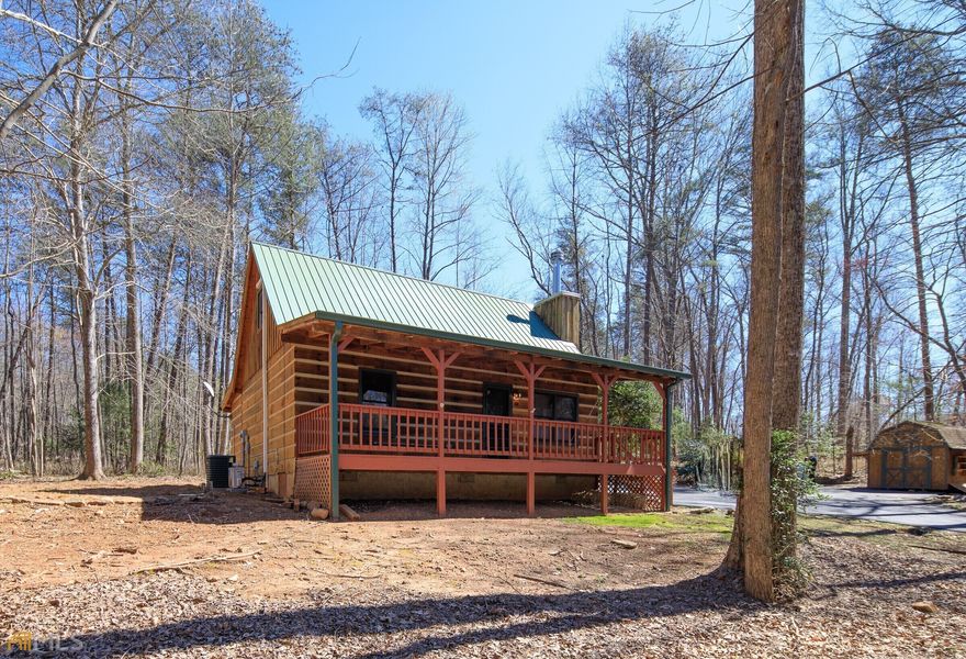 Are you looking for a MOUNTAIN GET AWAY or a YEAR AROUND HOME...this may be it. This cozy rustic cottage sits on 1.02 gentle lying acres. Just a short drive (+-6 miles) to downtown Dahlonega and in a small quiet,community of mostly rustic homes. Enjoy your morning coffee on the massive front porch which spans almost the entire front of the house plus a sunroom, on the back porch. Build a cracking fire in the greatroom fireplace. This open floor plan encompasses the living,dining & kitchen. The loft can be an additional bedroom. An added bonus are the road ways are paved and county maintained from McDonald Road and through out the development. NO HOA fees but there are restrictive covenants in the community.