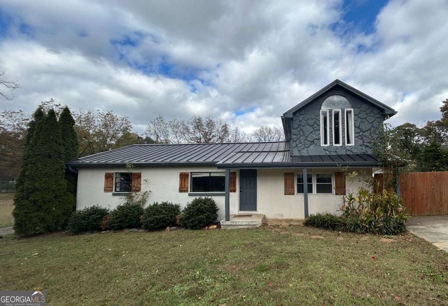 Welcome Home to 12 Franklin Dr, Cartersville GA    Discover the perfect blend of thoughtful updates and timeless appeal in this charming 112-story residence, nestled in a quiet, established neighborhood of Cartersville. This 3-bedroom, 2-bath home offers both everyday living ease and elevated style. Step inside to an upgraded kitchen featuring granite countertops, stainless-steel appliances, and clean, modern finishes. The kitchen seamlessly opens into a bright, open concept living and dining area with durable flooring and a neutral palette-making decor effortless. Two bedrooms and a full bath on the main level provide convenient, flexible everyday living. Upstairs, the upper-level suite delivers an elegant retreat with vaulted ceiling, arched window, and its own private bath ideal for guests, a home office, or a personal sanctuary. Outdoors, the fenced backyard on approximately 0.20 acres invites gatherings around the fire-pit, garden planning, or simply unwinding. A durable metal roof and updated exterior details enhance curb appeal and long-term value.    Just minutes from schools, shopping and dining, this home presents a rare opportunity to combine style, comfort and location in the heart of Cartersville. Don't miss your chance to make 12 Franklin Dr your next address.