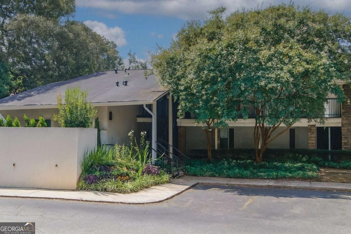 Enjoy tree-top views from this beautifully updated top-floor condo just minutes from downtown Atlanta. Relax on your private back balcony surrounded by mature trees with views of the picnic tables and walking trails. The kitchen has freshly painted white cabinets, newer granite countertops, a designer backsplash, new black and stainless-steel appliances, a new water heater, new stackable washer and dryer, new faucet, and more. This light-filled corner unit features real 3/4-inch oak hardwood flooring throughout and extra windows for abundant natural light. The spacious family room flows into a charming breakfast area, and the seller has added recessed lighting throughout along with stylish newer fixtures, new dimming light switches, updated outlets, and fresh paint. The bathroom includes white granite countertops, new water saving toilet, newer faucet, modern lighting, and updated flooring, while a generous walk-in closet provides plenty of storage. Fresh paint makes this home truly move-in ready. The gated community offers a pool, clubhouse, sand volleyball court, dog park, gym, car detailing station, and a large lawn area. The home is conveniently located near one of the gates for easy guest access, and you can enjoy views of the community right from your covered porch. The location is unbeatable-just minutes to the interstate, grocery stores, and within walking distance to many great restaurants and shops.