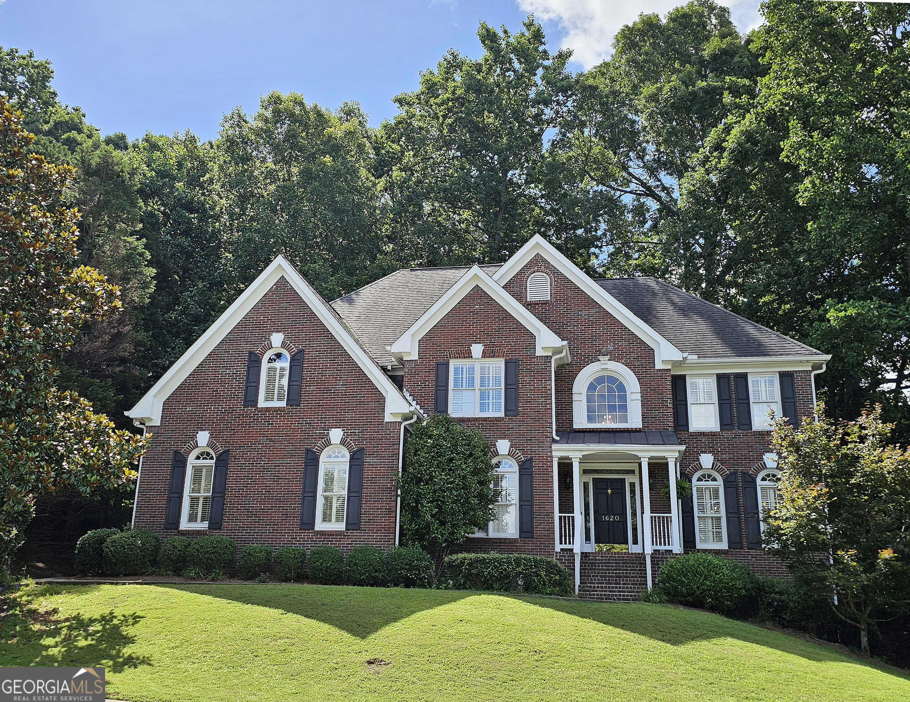 Beautiful brick traditional located in close walking distance to Park Glenn's Swim/Tennis facility and is a short distance from award winning, North Fulton County schools. Avalon, Downtown Alpharetta, Halcyon and the Greenway within easy reach. Home has a welcoming entry with hardwood floors, two story foyer leading to living room and separate dining room. First floor bedroom/office with French doors, palladium windows and adjoining full bath. The two-story charming family has French doors leading to a wonderful sunroom with lots of light coming through. The kitchen is light and bright, making it a pleasure to cook meals. Gas cooking, stainless steel appliances, stone counters, breakfast bar, pantry. Rear stairs lead to the very spacious primary suite with plantation shutters, a sitting area, trey ceiling, two separate bathroom vanities, storage or TV cabinet. Two other bedrooms with jack and jill bath. Upstairs laundry room with utility sink. Finished lower level with large entertainment room, bedroom, full bath and shower, exercise room and unfinished storage/equipment rm. Wonderful outside space, great for entertaining.