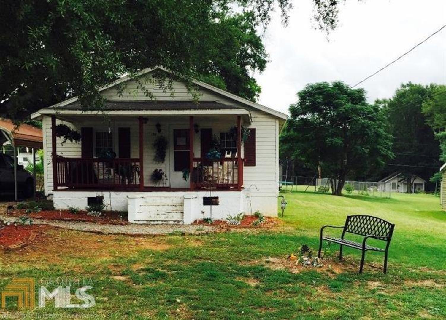Rental house in downtown Lavonia. 2 bedroom, 1.5 bath, currently rented for $650 per month with long term tenant in place (rent can be increased, currently month to month). Living room, dining room, and kitchen flow together for nice living space. Covered front porch, back deck, large yard and big stately trees make this a great place to call home, either for you or a tenant. House is in good condition but could use some updates. There is some siding damage on one side of the house. It appears there are wood floors under the linoleum. Fix and flip, keep and rent, so many options for this home in the thriving town of Lavonia!