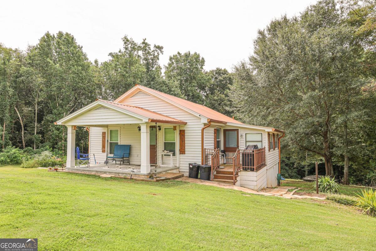 Charming 3 Bedroom Home on Nearly an Acre in Rural Clermont, GA! Welcome to peaceful country living with this 3 bedroom, 1 bathroom home nestled just outside of Clermont. Situated on just under an acre of gently sloping yard, this property offers the perfect blend of privacy and convenience, with beautiful wooded views and plenty of open space for outdoor enjoyment. Step inside to a welcoming living room area with room to lounge. Off the living room is a bright, updated kitchen featuring white cabinetry, modern appliances, and a large window overlooking the backyard. The cozy living and dining areas are perfect for family gatherings or quiet evenings at home. The partially finished basement provides additional storage space or the ability to finish it out and make additional living space. Outside, enjoy the wide-open yard-perfect for gardening, pets, or playtime-and a covered shelter ready for your outdoor projects or hobbies. With no HOA, this property offers flexibility and freedom for your lifestyle. Don't miss the chance to own a slice of the countryside while still being within a short drive to downtown Clermont, schools, and major highways. Schedule your private showing today! ****Seller is willing to negotiate leaving certain furnishing items with potential buyer****