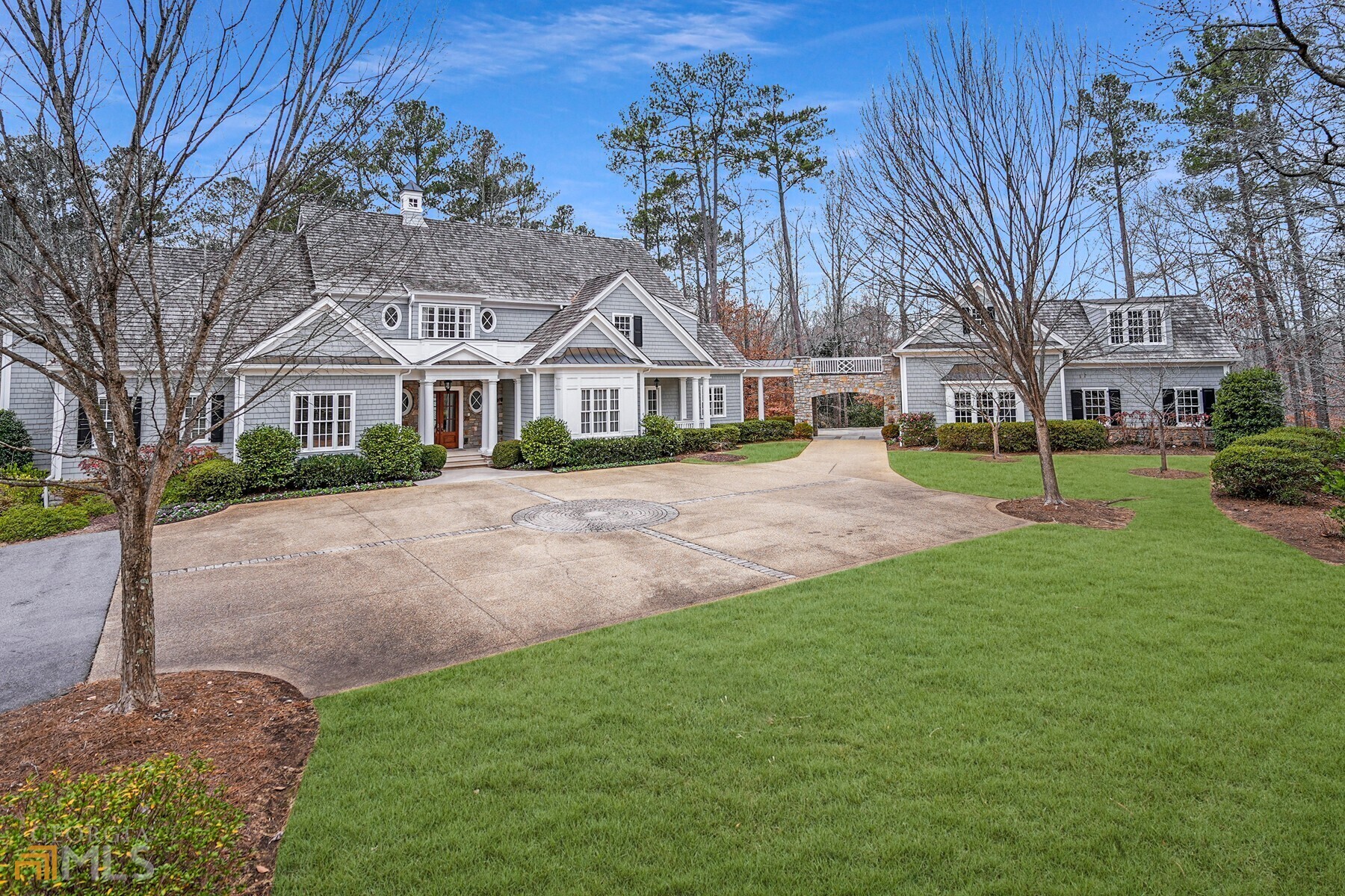 Sitting on 4+/- acres of beautifully manicured, super private property, this elegant Spitzmiller & Norris traditional New England style home exudes an abundance of dignity and charm. Built in 2002 by Phillip Clark Custom Builders, the homes open floor plan is perfect for entertaining with French doors leading to the fabulous bluestone patio and walkout level backyard from both the formal living room and large family room. A formal dining room with silver closet, light filled gourmet kitchen with breakfast area and sizeable butler's pantry are an entertainer's dream. Completing the main level is the handsome mahogany paneled library/office with fireplace and an owner's suite with separate marble his and her bathrooms and spacious custom closets. On the second level of the home are five large bedrooms, each with their own ensuite bathrooms. One of these bedrooms is currently being used as a large office space with two workstations. The terrace level is also an entertainer's delight with a gaming area, gorgeous custom wine cellar and tasting room, large movie theater with updated electronics, gym, one additional bedroom and bathroom and plenty of great storage area. There is an elevator to all three levels of the home. The fully fenced grounds of the property are equally as lovely as the interior. Great level yard and beautiful gardens surround the home. The property is well prepared for weather emergencies being served by a whole-house generator. Located in close proximity to Buckhead, Sandy Springs and Chastain Park, all the local public and private schools and the best shopping and restaurants these areas have to offer. There is no doubt about it - this home is perfect for the buyer who wants supreme privacy along with modern convenience. Welcome HOME!