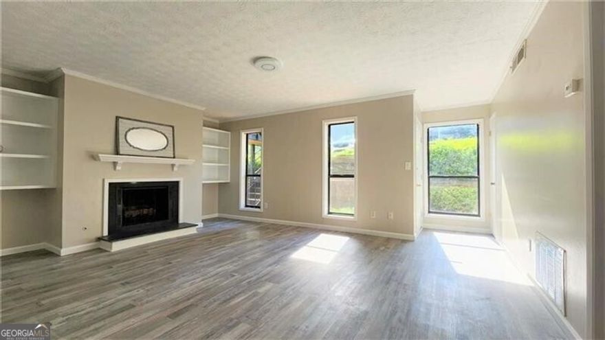 Nestled in the sought-after Walton High School district, this beautifully updated 2 bedroom, 2 bathroom condo offers an inviting blend of comfort, style, and convenience. Step inside to discover an open and bright living space, complete with fresh paint and modern finishes. The kitchen is a chef's delight with granite countertops and a vented gas range. Spacious living room is ideal for relaxation and entertaining and features a cozy fireplace that provides warmth on cool evenings. A rare feature for similar condos is the park like view from the back balcony, as there is a neighborhood greenspace and large pond located behind the unit. Residents of this community enjoy access to amenities such as a swimming pool, tennis, and very well-maintained common areas. This condo's ideal location is within close proximity to major highways, shopping centers, restaurants, parks, and entertainment, making daily life incredibly convenient. Call today!