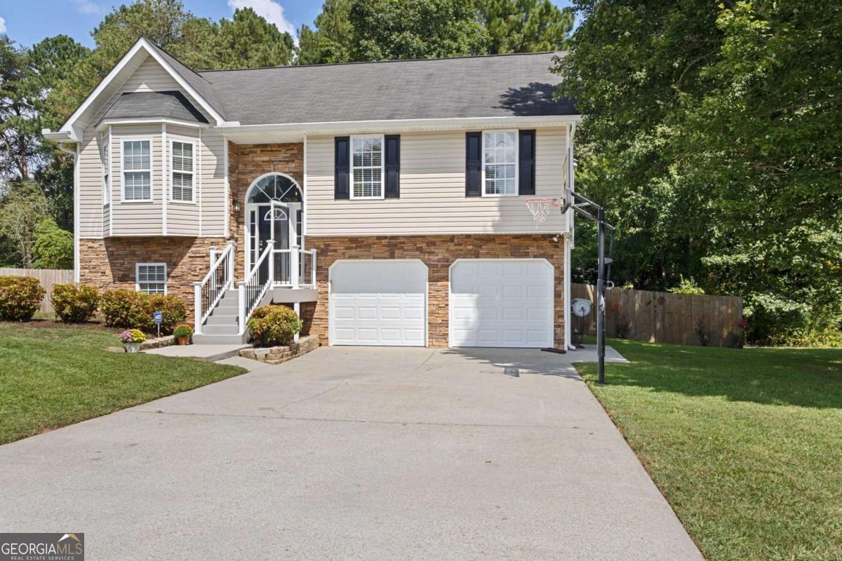 And THIS is why you purchase a house in rural Georgia. This retreat home would easily sell for $75K-$100K more than this list price just a few miles closer to the metro area, and for good reason! You just absolutely won't believe what you get for this price! Almost 2000 sf of completely remodeled beauty. New EVERYTHING! Hardwood flooring throughout, custom cabinets, quartz countertops, new fixtures, newer HVAC, new septic drain field lines, fresh paint, and even new insulation in the attic! Can we talk about the outdoor oasis for a minute?! 600 sf of two-tiered composite deck with PVC railing (I could talk about the benefits of this forever) overlooking a 27 foot salt water pool with heater, AND a low-maintenance 6,000 gallon Koi pond with waterfall and filter! All of this is fully fenced in on almost a half an acre with privacy fence! 3 gorgeous bedrooms and 2 stunning bathrooms upstairs PLUS a huge bedroom/office/bonus room/mother-in-law suite/teen suite/man cave or craft room downstairs with it's own private bathroom. The freshly epoxied garage floors are so clean you may feel a little guilty even stepping on them! Did I mention NO HOA? Another benefit of Rockmart? While it is growing, and one of only a few towns/cities projected by Zillow to increase in value over the next year, it still qualifies for a ZERO PERCENT down payment with a USDA loan! If this lasts 5 minutes, I'll be surprised!