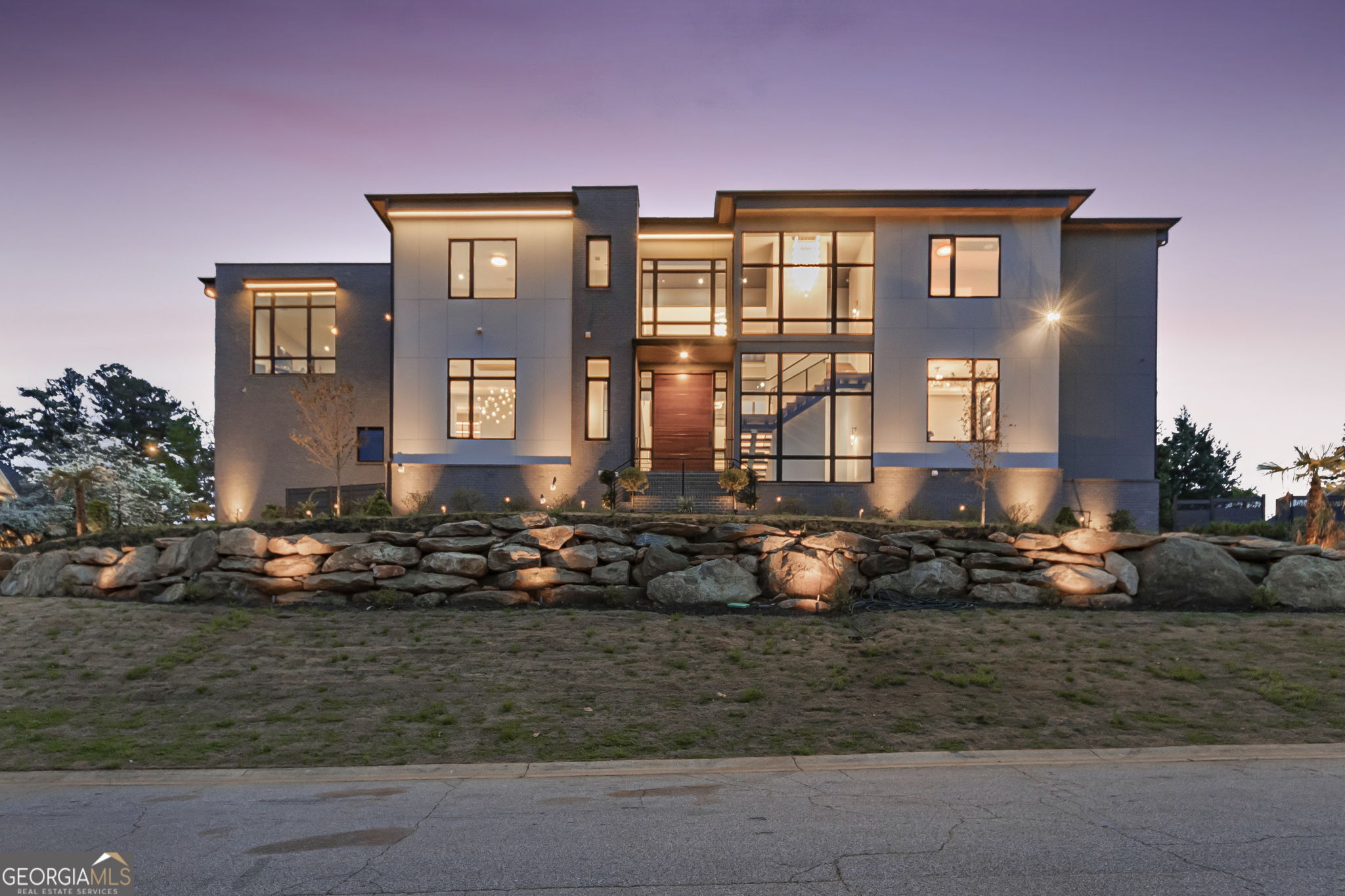 A modern masterpiece of distinction. Nestled on a 0.75-acre corner lot one of the largest lots within the prestigious Indian Hills Country Club and located in the highly sought-after Walton High School district. A stunning curb appeal, sleek Casement windows, featuring wood-look panels, architectural lighting beautifully manicured lawns, and impeccable attention to detail. This home offers an array of exceptional features, seamlessly blending opulence, innovation, and comfort on each level even to the most meticulous buyer. Progress through the grand pivot door into the soaring 24ft high ceiling foyer and family room adorned with premium sophisticated chandelier lighting, mesmerizing built ins and fireplace. dramatic floating staircase, with motion sensor lights, setting the tone for the sophistication and elegance that awaits. State-of-the-art kitchen features, exquisite stunning cabinetry, Quartzite waterfall countertops, commercial-grade appliances that ensures an immersive entertainment experience complete with acoustic wood panels. The adjacent scullery provides the perfect setup for hosting gatherings and events. The living space expands effortlessly outdoors through sleek nano accordion doors, connecting to a cozy outdoor. Unwind in style in the expansive primary suite, complete with bespoke closets and a lavish resort-style bathroom featuring a stunning stone soaking tub. Additional bedrooms are equally impressive, boasting generous proportions and private en-suite bathrooms. For added convenience, two spacious laundry rooms are strategically located on both the main and second levels, featuring custom cabinetry for effortless organization. This residence boasts a stunning terrace level perfect for entertaining, complete Wine cellar, a media room, state-of-the-art glass-enclosed gym, fully equipped sauna, lounge, family room, powder room, and a beautifully appointed guest suite with a court yard. Additional features include a convenient three-stop elevator and expansive Four-car garage. The outdoor space truly conveys the ultimate resort style and tranquility featuring a cabana, fire pit , saltwater pool and rejuvenating spa with a stunning waterfall feature overlooking the lush green yard. Indian Hills Country Club features a 27 hole golf course, newly renovated clubhouse, 8 tennis courts and 3 pools. Conveniently located near Shopping, Parks, Public and Private Schools.