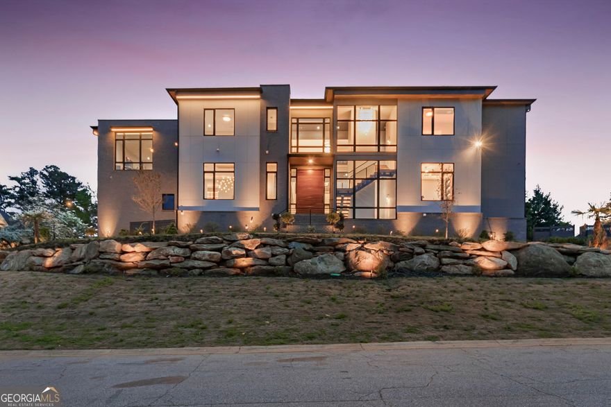 A modern masterpiece of distinction. Nestled on a 0.75-acre corner lot one of the largest lots within the prestigious Indian Hills Country Club and located in the highly sought-after Walton High School district. A stunning curb appeal, sleek Casement windows, featuring wood-look panels, architectural lighting beautifully manicured lawns, and impeccable attention to detail. This home offers an array of exceptional features, seamlessly blending opulence, innovation, and comfort on each level even to the most meticulous buyer. Progress through the grand pivot door into the soaring 24ft high ceiling foyer and family room adorned with premium sophisticated chandelier lighting, mesmerizing built ins and fireplace. dramatic floating staircase, with motion sensor lights, setting the tone for the sophistication and elegance that awaits. State-of-the-art kitchen features, exquisite stunning cabinetry, Quartzite waterfall countertops, commercial-grade appliances that ensures an immersive entertainment experience complete with acoustic wood panels. The adjacent scullery provides the perfect setup for hosting gatherings and events. The living space expands effortlessly outdoors through sleek nano accordion doors, connecting to a cozy outdoor. Unwind in style in the expansive primary suite, complete with bespoke closets and a lavish resort-style bathroom featuring a stunning stone soaking tub. Additional bedrooms are equally impressive, boasting generous proportions and private en-suite bathrooms. For added convenience, two spacious laundry rooms are strategically located on both the main and second levels, featuring custom cabinetry for effortless organization. This residence boasts a stunning terrace level perfect for entertaining, complete Wine cellar,  a media room, state-of-the-art glass-enclosed gym, fully equipped sauna, lounge, family room, powder room, and a beautifully appointed guest suite with a court yard. Additional features include a convenient three-stop elevator and expansive Four-car garage. The outdoor space truly conveys the ultimate resort style and tranquility featuring a cabana, fire pit , saltwater pool and rejuvenating spa with a stunning waterfall feature overlooking the lush green yard. Indian Hills Country Club features a 27 hole golf course, newly renovated clubhouse, 8 tennis courts and 3 pools. Conveniently located near Shopping, Parks, Public and Private Schools.