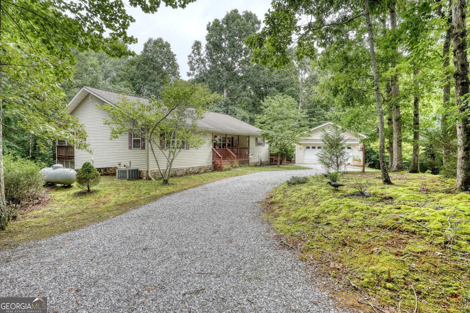 Charming RANCH HOME with the perfect blend of comfort and potential with this 3BR/2BA on the main floor. Step into this inviting open living room with cozy gas log fireplace and acces to the 30x12 screened in covered porch. It's simply ideal for relaxation or family gatherings. The kitchen with a generous dining area that offers great space for culinary adventures or family meal preparation. Convenient and functional with the utility room and breezeway leading out to one of the 2 car garages. There are endless possibilities for all your storage needs. The finished basement which has long term rental history has another bedroom, kitchen and bath. Fabulous home situated on a level lot, this home provides a great setting for outdoor activites and gardening possibilities.