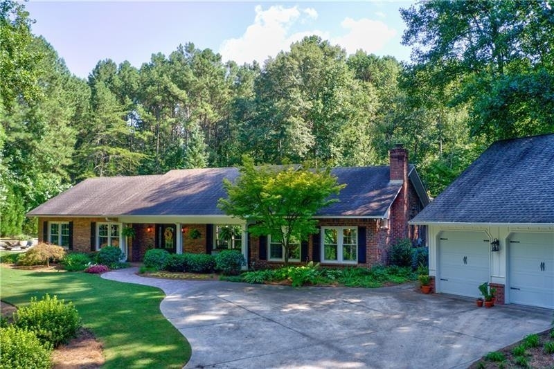 Serenity awaits you at this gorgeous 4-sided brick ranch, privately nestled in a partly wooded lot at the edge of horse country and yet so close to all Canton has to offer. As you enter the property's private drive, you will notice the oversized detached garage with an expansive climate controlled upper room providing additional living area, perfect for your hobby or small business. Also attached to the garage is the newly finished luxury apartment(both spaces are in addition to recorded tax record square footage). Take advantage of this for an in-law suite, college-age kids: or for rental income in this desirable area. Main dwelling welcomes you with a rocking chair front porch. The heart pine floors throughout the entire home were refinished in August of the year and will take your breath away when you enter. The formal dining room has beautiful hearth surrounded by authentic tile from Portugal. Two more masonry fireplaces bring warmth to the family room and master bedroom. Impressive kitchen with commercial grade GE Monogram oven/range . A new shiplap wall in the eat-in 12 person kitchen perfectly blends the classic timeless qualities of this home with a fresh farmhouse look. Three secondary bedrooms share two recently remodeled spa-like bathrooms. As you step out into the backyard, an oasis awaits you; cabana with brick fireplace, two sitting areas, a large dining area, and an outdoor kitchen. Professional landscaping enhances the natural beauty of the lot and joins the in-ground pool area perfectly with the patio and cabana. for the gardener, there are raised beds for planting. Truly something for everyone in the family with this home. Ideal location and meticulously cared for.