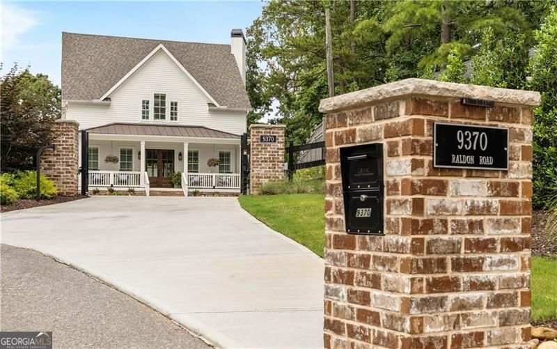 Custom Lakefront Home with Dock on Lake Lanier! Priced BELOW appraised value. Experience lakefront luxury with this stunning newly built custom home on Lake Lanier. Completed in 2024, this exquisite property offers the perfect blend of modern design, spacious living, and unparalleled lake views, located in the sought after Gainesville GA area, yet just inside Forsyth County. Enjoy breathtaking open water views and deep-water access. It's premier lakefront location with expansive water views from your private dock makes this property the perfect gem. The brand new 32' x 32' custom built dock by Martin Docks entertains well with single boat slip, spacious lower deck sitting area, and an upper party deck, perfect for enjoying the ultimate lake life. This Custom Home offers expansive open floor plan with high ceilings, large windows, and abundant natural light. Custom engineered white oak flooring throughout, provides a seamless and elegant look. Gourmet Kitchen with top-of-the-line appliances, custom cabinetry, and a large island opens to living area and large covered porch overlooking private courtyard. Gorgeous walk-in pantry with coffee bar, custom cabinetry and tons of storage. Four spacious bedrooms, five full baths, and two half baths. The primary suite features stunning lake views, a spa-like bath with a walk-in shower, soaking tub, and a custom closet. Two oversized laundry rooms, one upstairs, one down. Four beautifully designed fireplaces throughout the house. Huge Media Room equipped with a 160-inch screen, four custom built-in queen size bunk beds, and a full bath. Two family rooms, a game room with a full bar, ideal for entertainment and leisure. Three covered porches and one screened sleeping porch overlooking the lake. Enjoy the spectacular courtyard with an outdoor fireplace, large patio, outdoor grilling bar perfect for outdoor cooking, dining and entertaining. State-of-the-art finishes and features throughout. Entire house is insulated with spray foam walls and roofline for maximum energy efficiency, coupled with high-efficiency HVAC systems. Gated entry for privacy and security. This exquisite home combines luxury living with the tranquility of lakeside life. Whether you're looking for a primary residence or a vacation retreat, this property has everything you need for comfortable and stylish living. Don't miss the opportunity to own this spectacular home on Lake Lanier. For more information or to schedule a private showing, please contact owner/agent Kim McCrary.