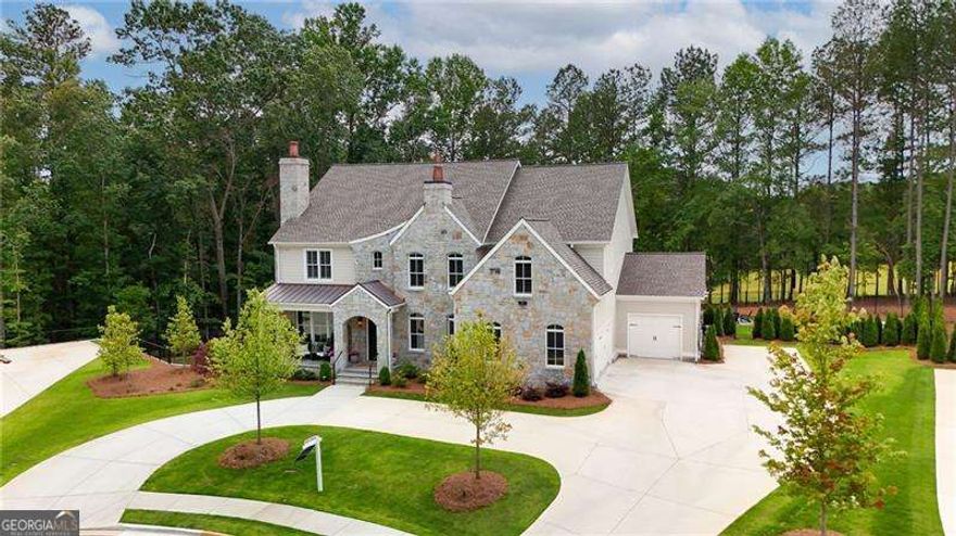 Back on the market to reasons unrelated to seller! Timeless Elegance Meets Custom Luxury - A Steve Powell Masterpiece in Owens Mill. Presenting a truly exceptional residence in the exclusive Owens Mill community-this custom-built estate by renowned luxury builder Steve Powell Homes is the crown jewel of the neighborhood, offering the largest home on the largest lot, meticulously designed for those who appreciate the finest in quality, style, and comfort. Perfectly positioned on a private, manicured cul-de-sac lot, this home is a showcase of refined craftsmanship with over $200,000 in high-end upgrades. The moment you enter, you're greeted by a grand sense of scale, light, and elegance. Every detail has been thoughtfully curated-from the pre-finished wide-plank hardwood floors that flow throughout, to the custom steel and wood stair railings, designer lighting, and clad windows that fill the home with natural light. The chef's kitchen is an entertainer's dream-anchored by an extraordinary 9'x8' quartz island, custom soft-close cabinetry, professional-grade appliances, a wine refrigerator, and a breakfast room wrapped in a wall of windows showcasing lush outdoor views. The home offers 6 bedrooms, 9 full bathrooms, and 2 half baths, including a luxurious main-level owner's retreat with a tray ceiling, spa-like bath featuring pristine white cabinetry, soaking tub, walk-in shower, and an oversized custom closet. A second owner's suite upstairs features double vanities, a soaking tub, separate shower, and generous storage-perfect for guests or multigenerational living. Additional living spaces include a formal dining room, an expansive family room with a stone wood-burning fireplace, and a formal study with its own elegant fireplace-an inviting space for work or reflection. The fully finished terrace level offers the ultimate in leisure with a billiard room, full wet bar, guest suite, and flexible entertaining areas. Outside, a true private oasis awaits: a heated saltwater pool and spa, Pennsylvania Bluestone decking, covered rear grilling porch, and a resort-style cabana with retractable glass garage door-the ultimate setting for year-round entertaining and relaxation. Enhancing this resort-quality retreat is an air-conditioned pool house with a full kitchen, wine cellar, and a full bathroom, creating the perfect blend of luxury, comfort, and convenience for your guests or personal enjoyment. A circular driveway, three-car epoxy garage, irrigation system, and custom exterior lighting complete this extraordinary offering. Located in a prestigious conservation community, just minutes from top-ranked Cherokee County schools, and close to the best of Milton and Alpharetta. Motivated seller-a rare opportunity to own a one-of-a-kind luxury home where every element reflects thoughtful design and exceptional quality.