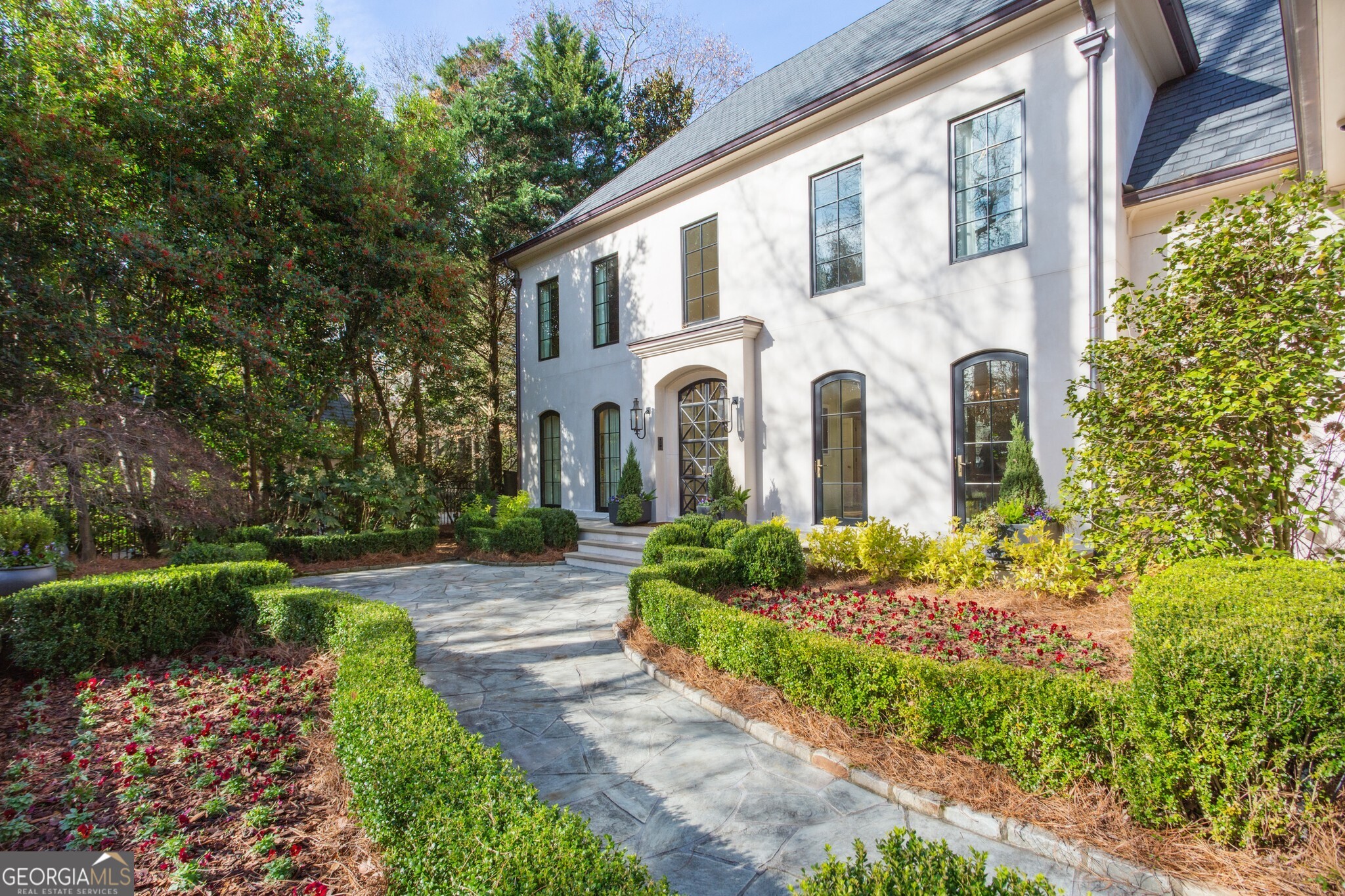 The search is over! This is the home you've been looking for! Perfectly nestled on a quiet, half acre lot at the back of the best cul-de-sac in coveted Chastain Park, this European real stucco home has it all! Fully remodeled in 2019 with unsurpassed finishes, this luxurious home was originally built in 1996 by the well-known Atlanta builder, Billy Benedict. With video monitoring and cameras throughout, this elegant "smart home" features 15 foot ceilings in the formal living rooms with built-ins and custom, curved baseboards, as well as custom fireplaces. There are limestone patios in the front and back of the house. The entire house is served by a Juturna water softening and filtration system, and you can enjoy a spa-like experience in the primary bathroom with heated floors and a steam shower. The stunning chef's kitchen features a Francois and Company custom range hood of mixed metals, Wolf double oven with 4 gas briers and a griddle, and an additional Wolf wall convection steam oven. The kitchen also features a morning bar with a sink and 2 refrigerator drawers. Both the lower and upper levels have offices with custom cabinetry and the lower level has a workout room and a media room. The top level includes a carpeted yoga studio, which could also serve as a music studio. An entertainer's dream, the beautiful backyard features an outdoor fireplace, an Italian wood-fired pizza oven, acoustic fence paneling for the ultimate in privacy, a saltwater pool and hot tub, and ample room to host family and friends - a perfect getaway right in your own backyard! Landscaping by E. Graham Pittman and Associates. There are 2 electric vehicle charging stations and golf cart parking in the garage. Guest parking includes 2 covered spaces, as well as 3 uncovered spaces. This property has great privacy with a stucco wall and iron fence at the entrance and is just a short, all-sidewalks walk to Chastain Park. All in all - a true masterpiece.