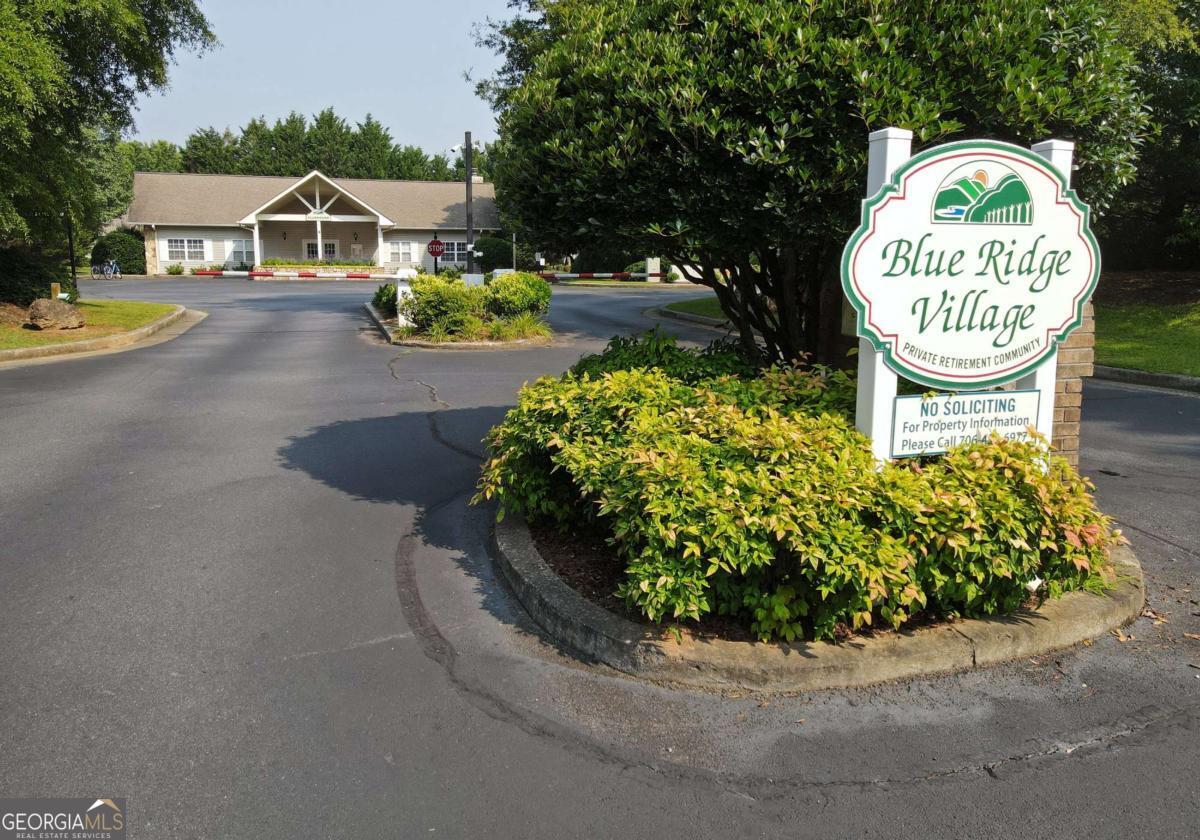 THE Place Seniors Love to Be! Located on the upper level this lot has city water and sewer to help with planned cost to build. All paved, gated community beside the Riverstone Medical Center, many eats and grocery for additional easy. Many love the comfort of being near to town yet having the country scenery and all Blue Ridge has to offer. The gated community provides weekly mowing (in season), garbage pickup weekly and more all for $1,500 per year.