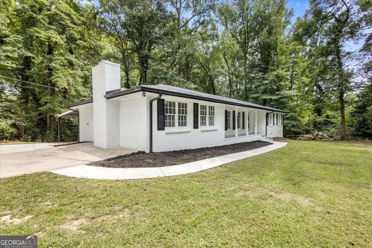 Fully renovated four-sided brick ranch on a 1.37-acre corner lot with a separate workshop! This 4-bed, 2-bath home offers an open floor plan, new kitchen with quartz counters, stainless appliances, and island, plus refinished hardwood floors throughout. Bathrooms feature custom tile, updated vanities, and modern fixtures. Enjoy two brick fireplaces, a screened porch, and an encapsulated crawlspace. Located just minutes from downtown Douglasville, Arbor Place Mall, local parks, and I-20, you'll have quick access to shopping, dining, and an easy commute to Atlanta. Rare find-move-in ready with classic charm and all the modern updates.