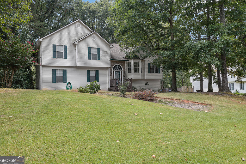 Turnkey ready and located in the highly desirable Cherokee High School District with no HOA! This beautiful home sits on a large, level lot with a private backyard that backs up to a wooded area. A long driveway and side-entry garage provide plenty of parking. Step inside to a newly renovated interior with fresh paint, soaring ceilings, and new floors throughout. The main level features a bright family room, a fully updated kitchen with white shaker cabinets, quartz countertops, newer appliances, tile backsplash, and eat-in kitchen space. A formal dining room offers the perfect setting for entertaining or can easily be converted into a home office. Upstairs you'll find three generously sized bedrooms, including a primary suite with a fully renovated bathroom showcasing dual vanities, quartz counters, and a separate tub/shower. The secondary bath has also been updated with a modern vanity and tub/shower combo. The finished walk-out basement expands the living space with a large multipurpose room, full bathroom, and a fourth bedroom option-ideal for guests, recreation, or a home office. Priced to sell, this one won't last long-schedule your private showing today!