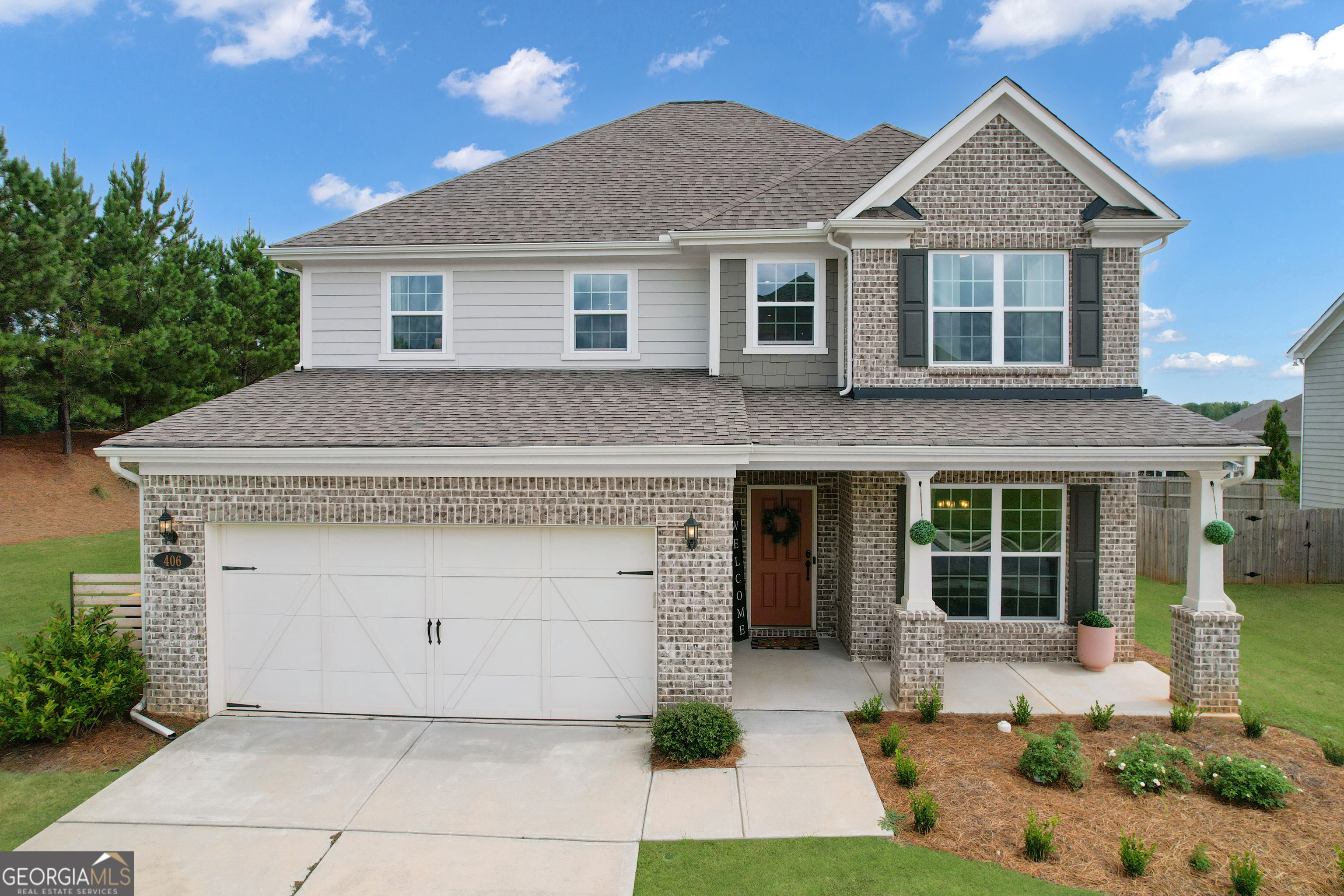 Warning: This Peachtree City home may cause sudden urges to host dinner parties, buy a golf cart, and never leave. From the moment you arrive at 406 Daker Dr, its timeless curb appeal invites you in-nestled on a corner lot with a welcoming front porch perfect for morning coffee or evening conversations. Step through the front door into a bright, open foyer where elegant crown molding, recessed lighting, and a trey ceiling in the dining room set the tone for refined living. The heart of the home unfolds in the gourmet kitchen, where quartz countertops, a tile backsplash, and white Aristokraft cabinetry meet Whirlpool stainless steel appliances, a 5-burner gas cooktop, vented hood, Blanco farmhouse sink, and a stylish coffee bar. A large island with seating seamlessly connects to the spacious family room, creating a perfect hub for entertaining. Tucked nearby, a butler's pantry and walk-in pantry ensure you'll never run out of storage space. Off the main living area, a sunroom floods the space with natural light, offering space for morning yoga and or a cozy space for a morning cup of coffee with gorgeous views of the backyard. A main-level guest suite with a full bath provides comfort and privacy for visitors, while a built-in office nook and mudroom/shoe station off the two-car garage add daily convenience. Upstairs, a loft-style bonus space greets you at the landing, offering the perfect spot for a reading nook, media space, or play area. The serene primary suite is a private retreat with a cozy sitting area, his-and-her walk-in closets, and a spa-inspired bath featuring a tile surround shower, soaking tub, and dual vanities. Three additional bedrooms-with walk-in closets-share a beautifully appointed bath with double vanity and tile floors. A laundry room with storage cabinetry and space for a folding station makes household chores a little more enjoyable. Outside, a patio awaits for summer barbecues or quiet evenings under the stars with a movie screen/firepit. The spacious backyard offers killer sunset views with lots of potential for gardening, a future pool or backyard gatherings. Beyond the home, Everton offers resort-style living with two swimming pools, a splash pad, open-air cabanas, tennis and pickleball courts, playgrounds, and meandering walking trails. With over 100 miles of golf cart paths connecting, you to Peachtree City's charm, you're just minutes from The Avenue's boutiques and dining, Trilith Studios, Lake McIntosh Park, and world-class golf. The convenience extends to being 20 minutes from Piedmont Hospital and just 30 minutes from Hartsfield-Jackson International Airport. With the upcoming U.S. Soccer Federation Headquarters nearby, the area's future is as bright as its present. 406 Daker Dr is more than a home-it's a lifestyle where elegance, comfort, and community meet.