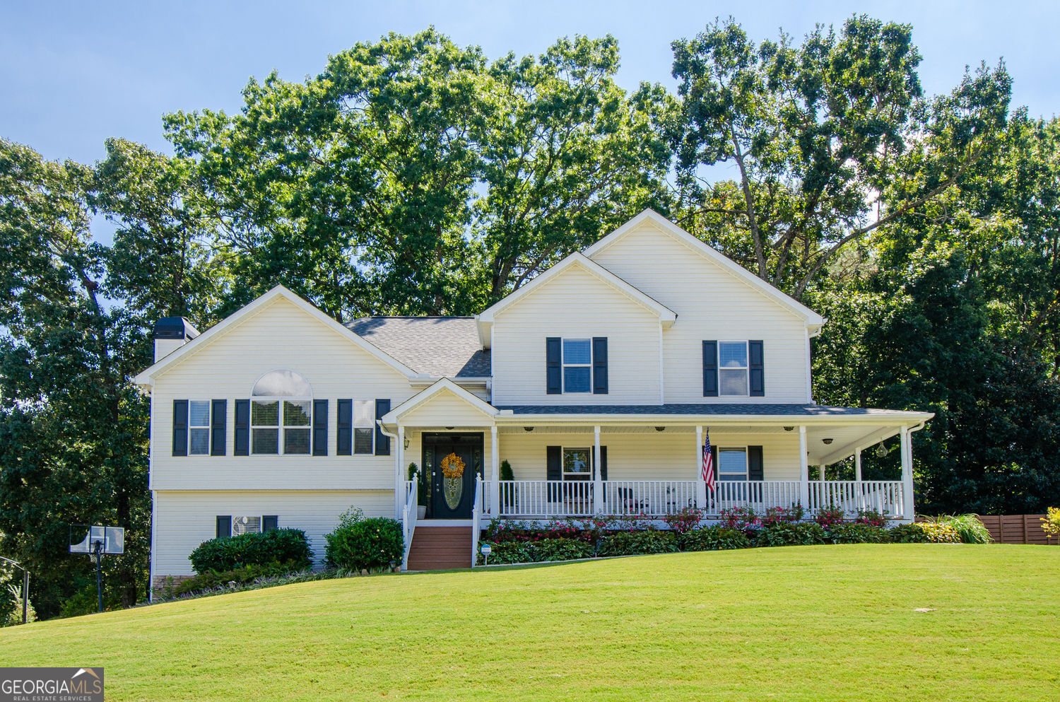 Welcome to this move-in ready home in Sable Trace, perfectly set on a spacious half-acre+ corner lot with a charming wrap-around porch made for relaxing. Thoughtfully maintained and designed for those looking for space in mind, this home offers flexibility and room to grow. The multi-level floor plan provides unique options for today's lifestyle. On the main level, you'll find a private suite with its own entrance from the porch-ideal for multi-generational living, an in-law suite, or even a guest retreat. You will find a large den, bedroom, full bath and laundry room in this space. Up the wide staircase, the heart of the home awaits. The beautifully updated kitchen features a custom island, granite countertops, convection oven, and abundant white cabinetry. The kitchen flows into the dining room-perfect for holiday dinners and celebrations. The inviting family room, highlighted by a cozy fireplace and built-in bookcases, completes this level. Upstairs, the spacious owner's suite includes an attached office or sitting area, a walk-in closet plus a secondary closet, and a relaxing bathroom with double vanity, tub, and separate shower. A large secondary bedroom and full bathroom complete the upper floor. Step outside to enjoy the backyard fire pit area surrounded by slate chips-a wonderful space for gathering. The landscaped yard includes a sprinkler system for easy maintenance and a large sought after fenced backyard The oversized drive-under garage offers incredible space, including an enclosed space and plenty of open storage. Located in the top-rated Cherokee County School District, this home also provides convenient access to interstates, shopping, and entertainment. With no HOA, you'll have the freedom to truly make it your own. This well-cared-for home in the welcoming Sable Trace community is ready for its next owner-don't miss the chance to make it yours!