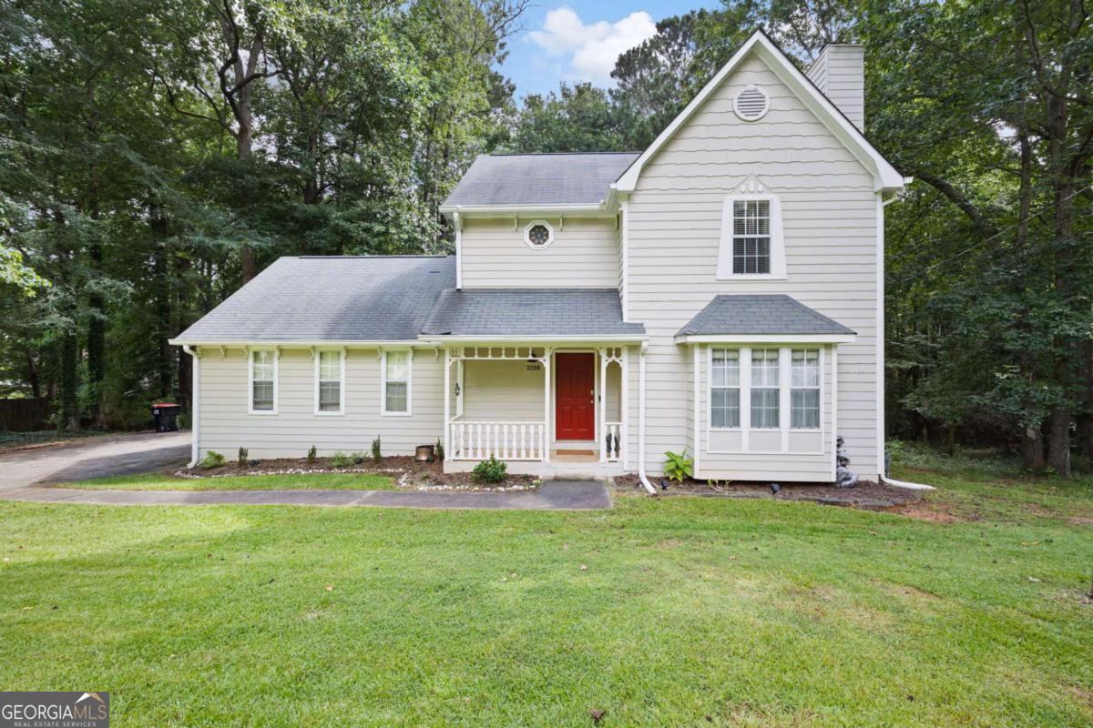 Charming & Move-In Ready in Douglasville! Welcome to this beautifully maintained 3-bedroom, 2.5-bathroom home tucked away on a peaceful lot. From the inviting covered front porch to the serene backyard, this home offers comfort and charm. Step inside to find a neutral color palette and luxury vinyl plank flooring throughout the main level. The cozy living room features a stone fireplace, creating a warm and welcoming space for relaxing evenings. The adjacent eat-in kitchen boasts white cabinetry, gas appliances, and a sunny dining area-perfect for casual meals or entertaining. The main level also includes a half bathroom and laundry area, thoughtfully positioned for functionality. Upstairs, the primary suite is a relaxing retreat, complete with an ensuite bathroom featuring a soaking tub. Two additional bedrooms share a full bath, providing space for family or guests. Enjoy the outdoors from the wood deck, which overlooks a private, tree-lined backyard featuring mature landscaping and garden beds ready for your green thumb. A two-car garage complements this well-appointed home, providing ample storage space. Located just minutes from shopping, dining, and Wellstar Douglas Medical Center, this is the perfect place to call home-don't miss your chance to see it!