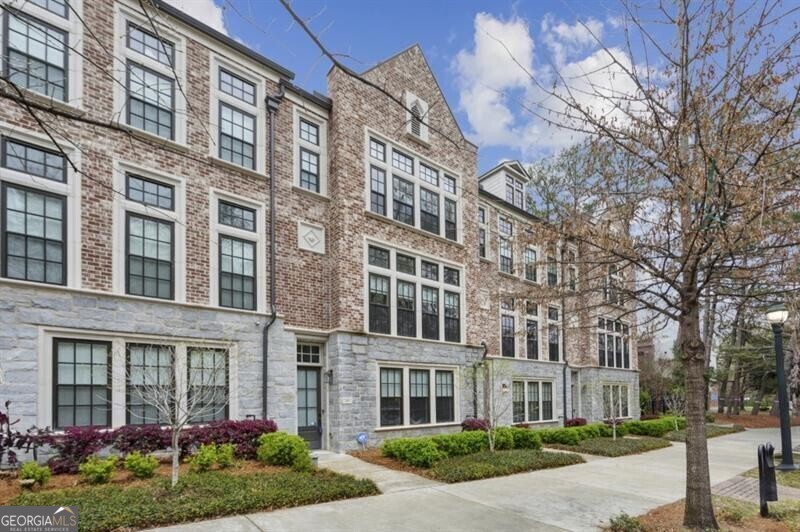 This meticulously designed townhome offers an elegant blend of luxury, comfort, and low maintenance living in one of Atlanta's most sought-after neighborhoods. From the moment you step into the grand two-story entryway, you're greeted by gleaming hardwood floors, custom lighting, and an abundance of natural light that flows throughout the open-concept main level. The showstopping kitchen features a suite of premium appliances, custom cabinetry, designer finishes, and stylish fixtures that make cooking both effortless and enjoyable. The adjacent family room strikes the perfect balance between elegance and comfort, while the covered brick balcony with a privacy screen creates a charming outdoor retreat. Entertain with ease in the spacious dining area, which offers versatile furniture placement options, making it equally suited for hosting large gatherings or intimate dinners. Upstairs, the primary suite is nothing short of dreamy, boasting spa-like tranquility with an en-suite bath that exudes sophistication. The generously sized secondary bedrooms offer stylish upgrades that are sure to impress, making them perfect for guests, children, or a home office. Additional highlights include a unique home gym, king-sized storage closets, and an oversized garage with extra parking behind. The private elevator ensures effortless, stepless access to all levels, adding to the home's ultimate convenience. The unbeatable and highly desirable location offers easy access to top-tier dining, shopping, and entertainment, all while nestled in a serene, residential setting.