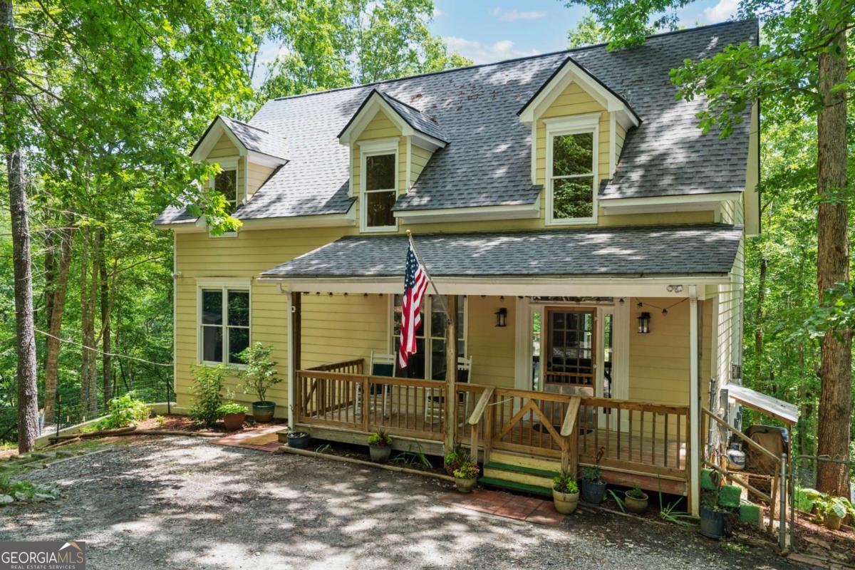 If you are looking for space, privacy, comfort and easy access to all that North Georgia has to offer, this beautiful retreat home provides the perfect balance of tranquility and convenience. This property is quiet and secluded, a charming home with a master on the main, resting on 4.65 acres, only 4 miles from downtown historic Dahlonega, Ga. Then again you can also grab some wings and a football game at the many diverse restaurants, or sit on the front porch with an adult beverage and commune with the deer. Take a breather to hike down to the natural stream and small waterfall or stay inside and view the beautiful forest while having breakfast on the back deck. Walk down the stairs to the terrace level and enjoy toasted marshmallows at the fire pit. Take a moment to enjoy the wood burning stove in the recreation room or maybe sit by the gas fireplace and watch a movie. There's also a fenced in backyard for your pups to enjoy. So many choices, all of them peaceful and comforting. And if you are looking for a Man Cave or She Shed, there is a separate 200 sq ft. building ready to create your dreams. All fun and ready to make your own. The kitchen has granite counter tops; the family room has designer copper inlay on the ceiling and wood floors accent the 1st and 2nd floors. The terrace level would also make a great Mother in-law Suite! This would be a great home or an Air-B&B rental. All in all, this is truly a rare combination of mountain retreat and practical living with large acreage, peaceful views, and high scoring schools.
