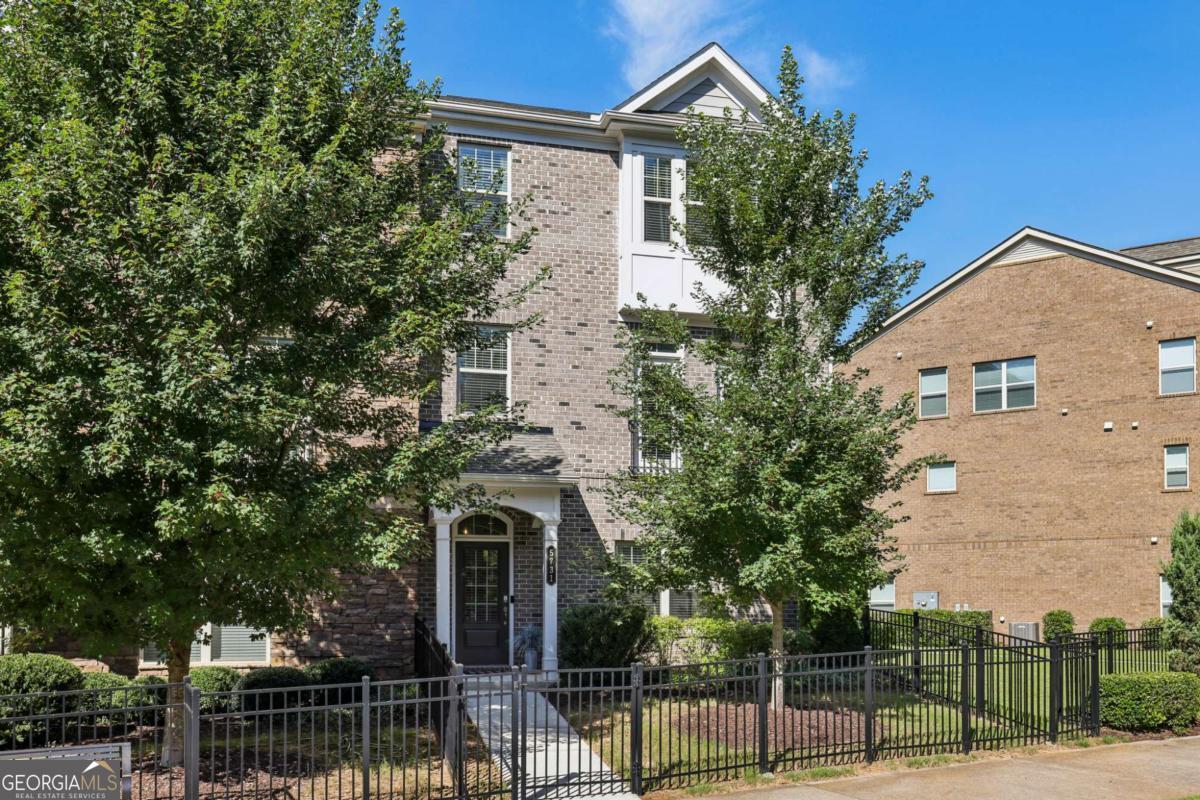 **Feels Like New!** This impeccably maintained end unit is move-in ready, requiring no additional work. Enjoy abundant natural light in this bright Yosemite floor plan, featuring 4 bedrooms and 3.5 baths, enhanced by extra windows. The gourmet white kitchen boasts elegant quartz countertops, stainless steel appliances, and a gas cooktop. The open layout showcases hardwood flooring and distinct living and dining areas, centered around the kitchen. The living space includes a niche ideal for a home office. The spacious primary suite offers a spa-like shower and double vanities, complemented by an upgraded laundry room. This unit also features the largest rear deck option available from the builder and an oversized garage with ample storage space. Located in a gated community with a swimming pool, it faces a picturesque tree-lined park, making it the finest unit in the Terraces at Peachtree Corners!