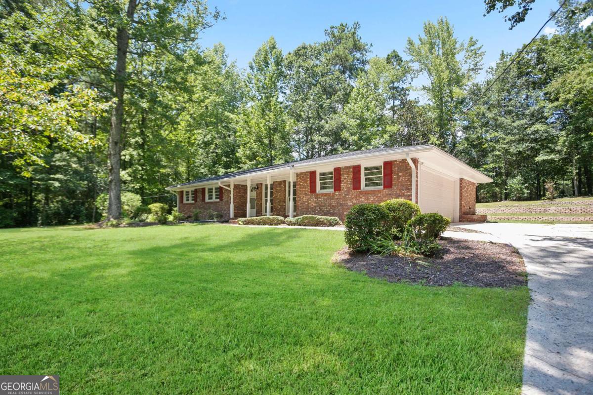Fall in love with this move-in ready 3 bedroom, 2 bath home located in a quiet Fairburn neighborhood. This updated brick ranch offers a perfect blend of charm and modern convenience. Featuring a spacious front yard and a beautifully landscaped backyard, the property sits on a little over 0.5-acres-ideal for outdoor entertaining, gardening, or simply relaxing. Inside, you'll find fresh paint, stylish light fixtures, and brand-new appliances. Recent updates include a 3-year-old roof and a 5-year-old water heater, providing peace of mind. A 2-car garage and 4-sided brick construction add value and durability. This Fairburn home offers easy access to schools, shopping, dining, and major highways, making it an excellent choice for families, first-time buyers, or anyone looking for a fully renovated brick home with a big yard in a peaceful setting. Don't miss your chance to make this beautifully updated brick home yours-schedule your showing today and fall in love with everything it has to offer!