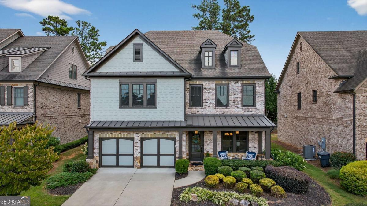 Welcome to your dream home in one of East Cobb's most coveted neighborhoods, within the highly acclaimed Walton High School district. Just minutes from the prestigious Atlanta Country Club, home to one of Georgia's premier golf courses, and the scenic Chattahoochee River National Recreation Area, this residence offers the perfect combination of luxury, lifestyle, and convenience. Enjoy close proximity to East Cobb Shopping Center, Whole Foods, top-rated schools, and a vibrant dining and retail scene. Nestled in a desirable swim and tennis community with clubhouse, the home invites both relaxation and recreation. A charming front porch sets the tone, ideal for enjoying morning coffee or unwinding in the peaceful surroundings. Inside, soaring ceilings, rich hardwood floors, and abundant natural light create a bright and welcoming atmosphere. The spacious living room features a cozy fireplace and custom built-ins, flowing seamlessly into the open-concept kitchen. Designed with entertaining in mind, the kitchen includes updated stainless-steel appliances, a gas cooktop, generous cabinet storage, a walk-in pantry with custom shelving, and a large island with bar seating. A butler's pantry with floating shelving connects to the elegant dining room, perfect for hosting gatherings. The main level also includes a guest bedroom with a full bath, offering comfort and privacy for visitors. Upstairs, the expansive primary suite boasts a double tray ceiling, sitting area, oversized custom walk-in closet, and a spa-like bath. An additional guest suite with its own walk-in closet, two more bedrooms with shared full bath, and a large laundry room complete the upper level. The backyard is designed for year-round enjoyment, whether entertaining, grilling, or simply relaxing outdoors. This home is more than a residence, it's a lifestyle. Don't miss the opportunity to make it yours in one of Marietta's most desirable locations.
