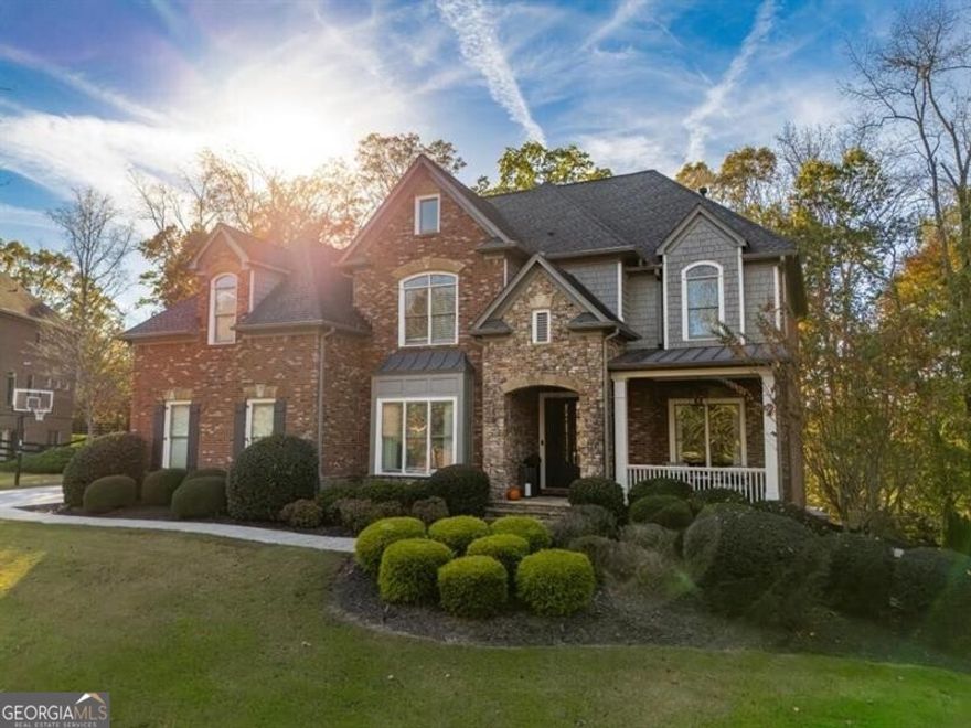 It's Spring and time to make your dream home a reality! Sophisticated style meets modern luxury in Clearbrooke, a gated enclave in Milton. This very special property is set on a beautifully landscaped acre lot, surrounded by a grove of broad-leaf trees, providing privacy and colorful displays in spring and autumn. Inside, the design details are both elegant and inviting. The grand gathering room is highlighted by an impressive stacked-stone fireplace and a two-story wall of windows. An open kitchen with Quartz countertops and an oversized dining island features chef-inspired appliances (Wolf gas range and Sub-Zero refrigerator/freezer). The adjacent dining room can seat 12 or more. The parlor off the front foyer could serve as a library or home office. The Guest Bedroom on the main floor is both private and accommodating. A relaxed keeping room opens to the upper deck. A Western exposure allows you to enjoy sunsets filtering through the trees and evenings lit with garden lights. Rich hardwood floors and distinctly crafted light fixtures throughout. The resort-inspired terrace-level is surely a perfect place for entertaining, featuring a sleek kitchenette and bar, fireplace lounge, gaming area, home gym, steam shower, guest suite, laundry room, and a private entrance home office. Walk out to the saltwater pool (40 feet long and heated as needed) and infinity-edge spa set on a TimberTech deck and a stone patio, which opens to the sheltered back lawn with "old world style" stone terracing. The covered patio below the deck provides a refuge and a cozy spot to mingle. A well-appointed Owners' Suite on the 2nd level includes a fireplace, a sitting area with window views to the back of the property, and an elegant Tuscan Marble bathroom with a soaking tub, large shower, separate vanities, and a custom-organized closet. The catwalk overlooks the living spaces below and leads to three additional, large bedroom suites, each with its own bathroom and walk-in closet. One of two laundry rooms is also on the 2nd level: with custom cabinetry, a folding counter, and utility storage. On the third level is a finished bonus room with a half bath. Additional features are a built-in mud area with storage, 2 electric car charges in the garage, remote control shades, and outdoor lighting. This gorgeous HOME is located near the best of North Fulton's sought-after lifestyle: local farm-to-table restaurants, chic boutiques, parks and walking trails, award-winning schools, and the "Live Work Play" hubs of downtown Crabapple, Alpharetta, Avalon.