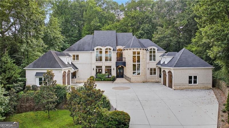 Stunning European-inspired estate nestled on a private, gated lot with an elegant motor court and timeless curb appeal. This exceptional residence features soaring ceilings, exquisite moldings, and a seamless blend of luxury and livability. The brand-new PebbleTec saltwater pool is walk-out from the main level and includes a stylish pool cabana-perfect for entertaining year-round with heating and a serene, private backdrop. Inside, the custom kitchen impresses with a large island, bespoke cabinetry, and an open flow to the breakfast area and fireside family room. A guest suite on the main offers comfort and convenience, while the expansive primary suite upstairs is a true retreat, featuring a marble-clad bathroom with custom tile-work, morning bar, and spacious walk-in closet. All secondary bedrooms are en-suite, and the finished terrace level includes a media room, full bar, gym, and full bath. With four-car garages, ample space for entertaining, and refined finishes throughout, this home combines elegance and function in a coveted location-just minutes from top private schools, golf, shopping, and dining.