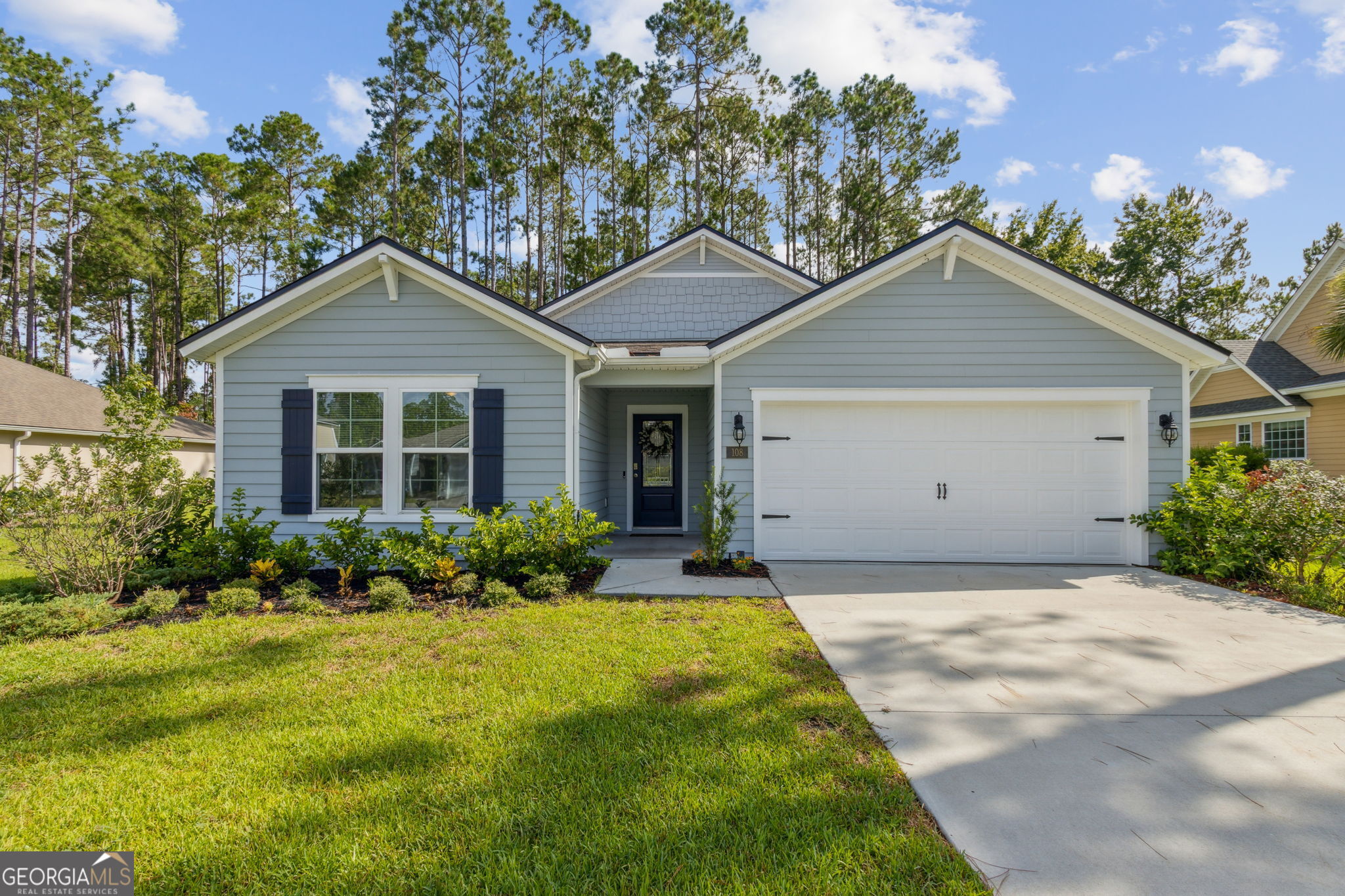 Welcome to 108 Angler Lane, a nearly new five-bedroom, three-bathroom home located in the prestigious gated community of Osprey Cove. Tucked away on a quiet cul-de-sac with no through traffic, this beautifully designed home offers privacy, peace, and a thoughtfully planned layout perfect for both everyday living and entertaining. Step inside to an open-concept floor plan featuring a spacious living area and a stunning kitchen with a large center island, gas range, and ample counter space-ideal for gatherings and culinary creations. The main suite is generously sized and features an oversized walk-in closet and a luxurious bathroom with dual vanities and a tiled shower. Out back, enjoy a completely private backyard with a covered lanai, perfect for relaxing or dining outdoors. Additional highlights include plenty of storage space, easy access to the neighborhood's scenic walking trails, and a convenient location on the side of the community that allows for quick access in and out. This home offers the best of coastal Georgia living in a premier golf and boating community. Don't miss your chance to make it yours!