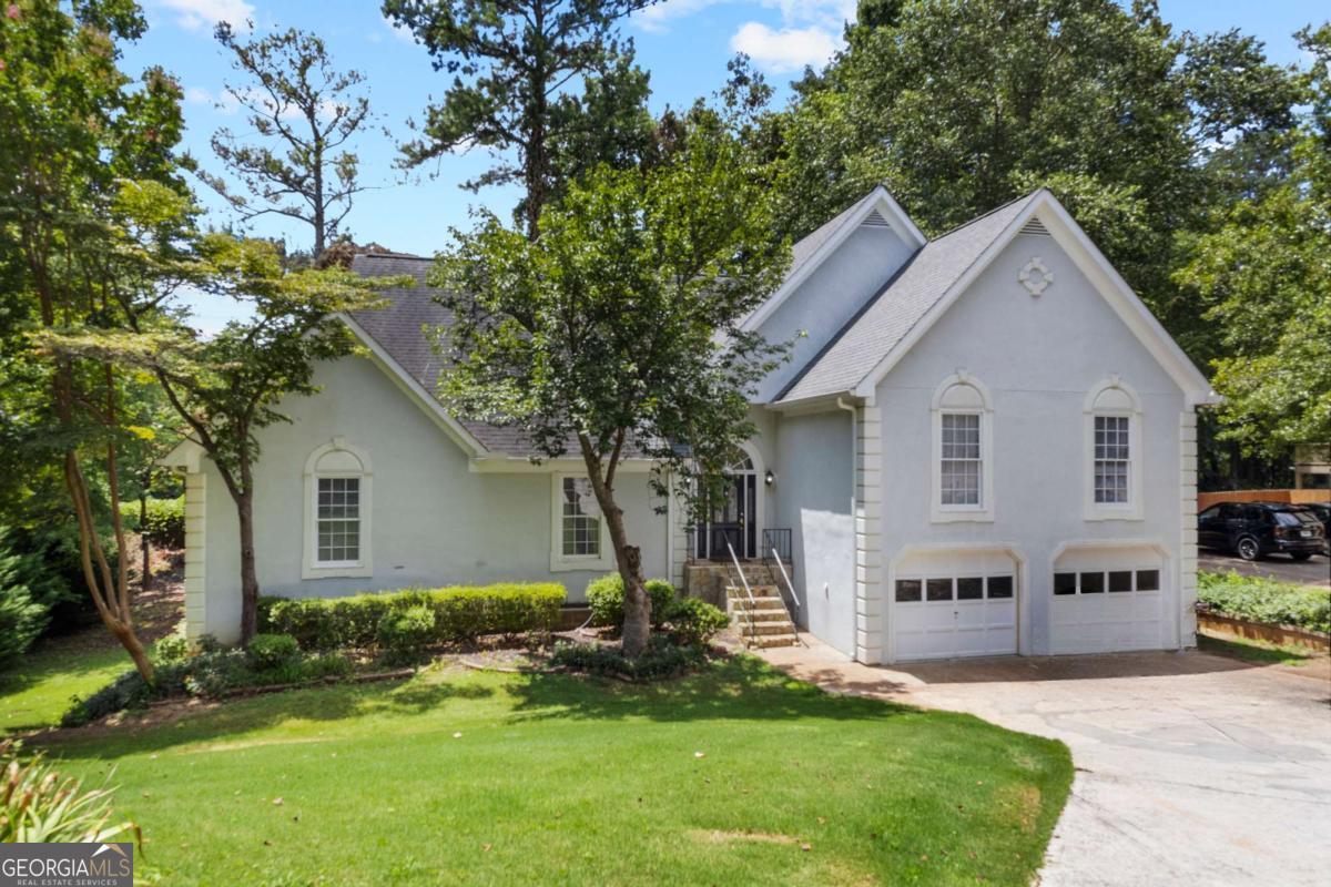 Welcome to your dream home in the heart of East Cobb, nestled in one of the most desirable and top-rated 10/10 school districts around! This stunning 6-bedroom, 3.5-bath beauty offers the perfect blend of comfort, charm, and functionality. From the moment you step inside, you'll be captivated by the spacious layout and thoughtful details throughout. The inviting family room features a cozy stone fireplace and custom built-ins, perfect for gatherings or quiet evenings at home. Entertain in style in the elegant formal dining room, or cook up something special in the light-filled kitchen, complete with classic white cabinetry, double ovens, a generous pantry, and breakfast bar for casual meals. The luxurious oversized owner's retreat is a true sanctuary, boasting a deep tray ceiling, a bright bay window, spa-like ensuite with double vanities, soaking tub, separate shower, and a walk-in closet that dreams are made of. Secondary bedrooms are spacious and versatile, ready to accommodate family, guests, or a home office. Downstairs, the fully finished basement adds even more living space, featuring a kitchen area, large flex room, additional bedrooms, and a full bath. Step outside to enjoy peaceful mornings on the enclosed screened porch or host unforgettable summer evenings on the expansive deck. Perfectly located just minutes from I-575 and I-75, this gem offers unbeatable convenience in a prime East Cobb location. Opportunities like this are rare-don't let this one pass you by!