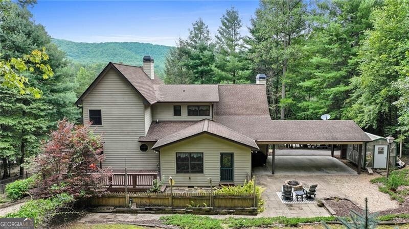Charming Mountain Retreat on Over an Acre in the Heart of North Georgia! Tucked away on a serene 1+ acre lot, this 4-bedroom, 3-bathroom home offers the perfect balance of privacy, charm, and natural beauty. Located just minutes from Nottely Lake and downtown Blairsville, with easy access to Blue Ridge, Lake Blue Ridge, Helen, Hiawassee, and Dahlonega, this property places you right in the heart of the North Georgia mountains. Step inside to a welcoming main level featuring a cozy fireside living room, a well-equipped kitchen with a generous prep and serving area, and a bright dining room. The spacious owner's suite offers a relaxing retreat with a screened porch, large closets, and a spa-like bathroom complete with a double vanity, soaking tub, and separate shower. A secondary bedroom, full bath, and laundry room complete the main floor. Upstairs, you'll find two additional bedrooms, a full bathroom, and a large bonus room ideal for movie nights, gaming, or a home office. Outdoor living is a highlight with two sunrooms, a screened front porch with mountain views, and a back deck overlooking a landscaped yard complete with blueberry bushes and a fragrant herb garden. Perfectly situated near Vogel State Park, Blood Mountain hiking trails, trout fishing spots, wineries, and shopping, this home is an ideal getaway for nature lovers and adventure seekers-or for those who simply want to unwind in the crisp mountain air. Whether enjoyed as a private retreat, vacation home, or year-round residence, this home captures the very best of mountain living!