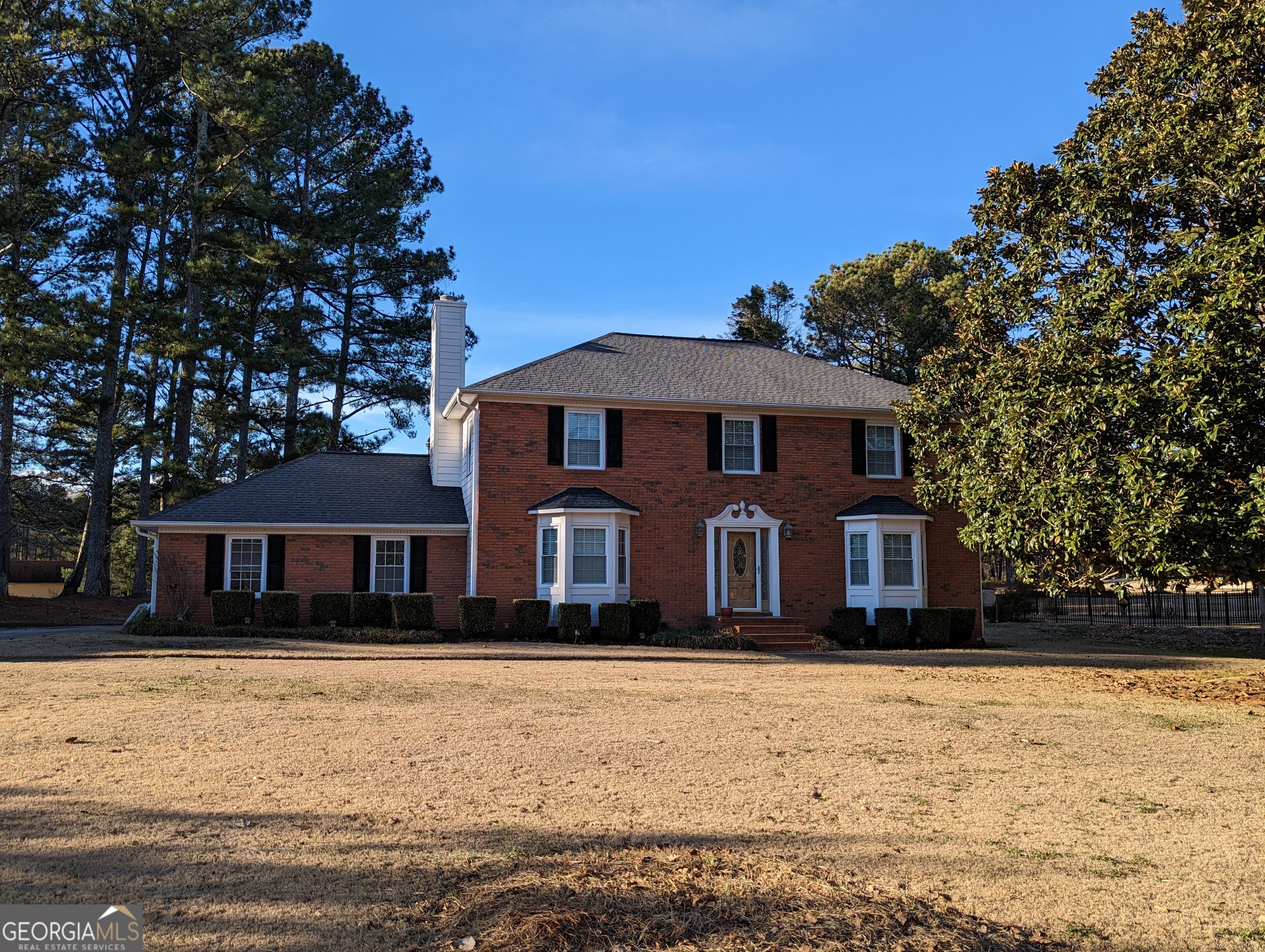 Executive-Style Living in Well-Established, HOA Community! Large, Beautiful, Spacious Home! On the Golf Course! Convenient to I-85. AVAILABLE NOW! Situated on the golf course, this traditional 2-story home features a vinyl and brick exterior with a level yard and stunning golf course views. Enjoy the outdoors on the patio or screened-in porch, or take a stroll on the sidewalks throughout the neighborhood. Inside, you'll find a 2-car garage, foyer entry, formal living room, family room, dining room, office, and eat-in kitchen with breakfast bar and pantry. The kitchen boasts solid surface countertops and hardwood floors flow throughout the main level. Retreat to the master suite with walk-in closets, whirlpool bath, separate shower, and tile floors. Additional features include cable TV connections and a sunroom. Don't miss out on this opportunity for splendid Sharpsburg living in a prime location near I-85. Pet negotiable for pets under 30 lbs. To schedule a showing, please call Gatekeeper at (770)-631-4334.