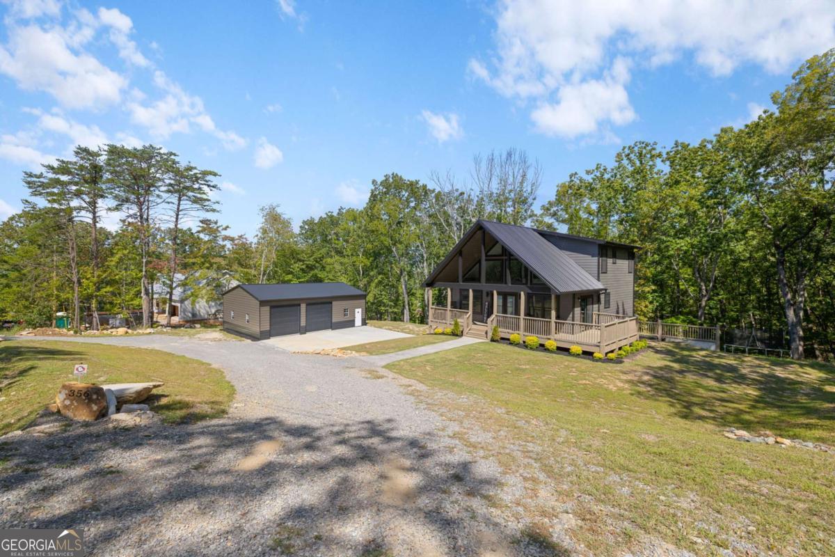 Custom-Built Home in Salacoa Highlands! Discover mountain living at its finest in this beautiful newer home located in the charming community of Salacoa Highlands in Jasper, GA. Perfect as a primary residence, vacation retreat, or investment property, this home offers a lifestyle that feels like a permanent getaway. Step inside through double glass doors into the stunning two-story living and dining area, open to a chef's kitchen featuring custom hickory cabinets with soft-close drawers, upgraded granite countertops, tile backsplash, new appliances, and designer black hardware. A private laundry room and half bath complete the main level. The main-level owner's suite is designed for comfort with custom lighting, double vanity with hickory cabinetry and quartz countertops, custom-built mirrored medicine cabinets, a soaking tub, and private deck access. Upstairs you'll find two spacious bedrooms, a full bath, and a loft-style balcony overlooking the main living area, plus a cozy nook perfect for a home office or reading space. Every detail in this home was thoughtfully designed, from the custom lighting throughout to the finished basement with a new bedroom and full bath. The circular gravel driveway includes a new two car garage that can house either your cars or your mountain toys and gear. Enjoy community amenities including a 22-acre lake with boat ramp, dock, bathhouse, picnic areas, and fishing. Conveniently located near Jasper's restaurants, wineries, and shopping, and just a short drive to Ellijay, Blue Ridge, and Dahlonega. Don't miss this opportunity to own a one-of-a-kind mountain retreat!