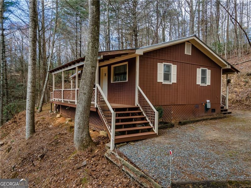 Charming fully renovated gem nestled on 1.49-acre lot in the tranquil North Georgia Mountains. This cottage offers the perfect blend of modern amenities and timeless character with 2 bedrooms and 1-bathroom and a private mountain front porch. The only noise you will hear are the babblings on Harper Creek. New roof was installed 2019. New Chefs kitchen with gas stove, stone counter tops, new cabniets, and water filtration system under the sink. The bathroom offers walk-in tile shower and gorgeous granite countertops. HVAC was replaced 2019. 10 minutes from Downtown Ellijay. 5-minute drive to Roo Mountain Vineyard. 4-minute drive to Shitake Mushroom Farm. Get closer to nature and find some of the best hiking trails in North Ga. Carter's Lake and boat launch is down the road.