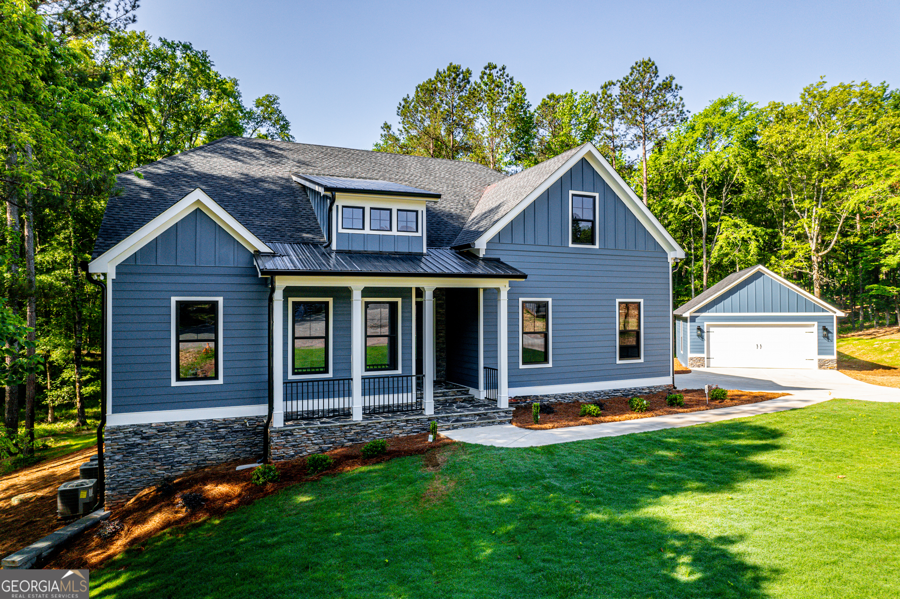 STUNNING NEW HOME ((BRING THE BOAT)) LAKE OCONEE **GATED COMMUNITY** HARMONY BAY ON LAKE OCONEE. Three levels of quality and beauty and it shouts "Bring the whole family" 6 Bedroom custom retreat with additional 24'X26' detached garage. Exclusive community with multiple boat slips, walking trails, cook out/gathering spaces and private boat ramp. Quaint Community with only 43 homesites. Family room features full wall accordion glass feature opening to your covered entertaining game day deck with gas fireplace and natural wooded view. Full finished basement sports a media room and covered game day patio with gas fireplace. Super custom features galore. Owner's retreat includes spa inspired tile shower with dual rain heads and removable shower with dual controls. Gourmet kitchen with huge island spills into the super open concept. Quality at every turn.