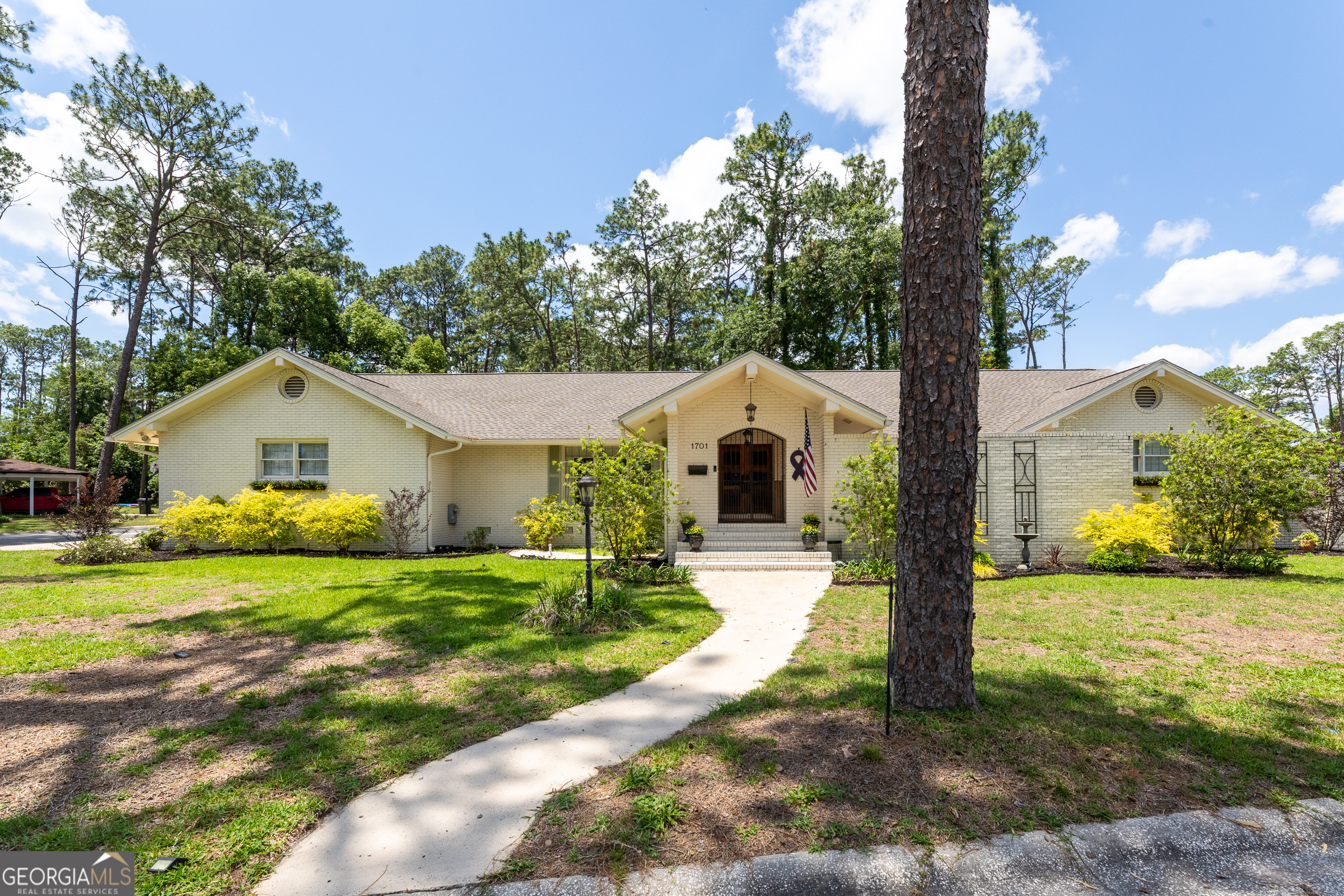 Welcome to 1701 City Blvd-a well-loved and beautifully maintained brick home tucked right in the heart of town. This one has all the charm, from the manicured lawn and sweet curb appeal to the cozy, lived-in feel that just wraps around you when you walk through the door. Located in the Cherokee Heights neighborhood, this spacious 4-bedroom, 3-bath home with 3231 sq foot of space sits on a beautifully landscaped corner lot with curb appeal to spare! Step inside to discover bright, open living spaces, a split floor plan, and tons of natural light throughout. The large kitchen is a dream with ample counter space, a central island, and a layout perfect for entertaining. Out back, enjoy summer days in your private pool or relax in the shade on the covered deck. The fenced-in back and side yards offer plenty of room for pets, play, or gardening. You'll also love the front courtyard for morning coffee or evening chats. Need storage? There's a walk-up attic for all your seasonal items and more, plus a 2-car garage for parking and tools. The roof is only 2 years old, offering peace of mind for years to come. This gem has all the space you've been looking for inside and out in one of Waycross' most charming neighborhoods.